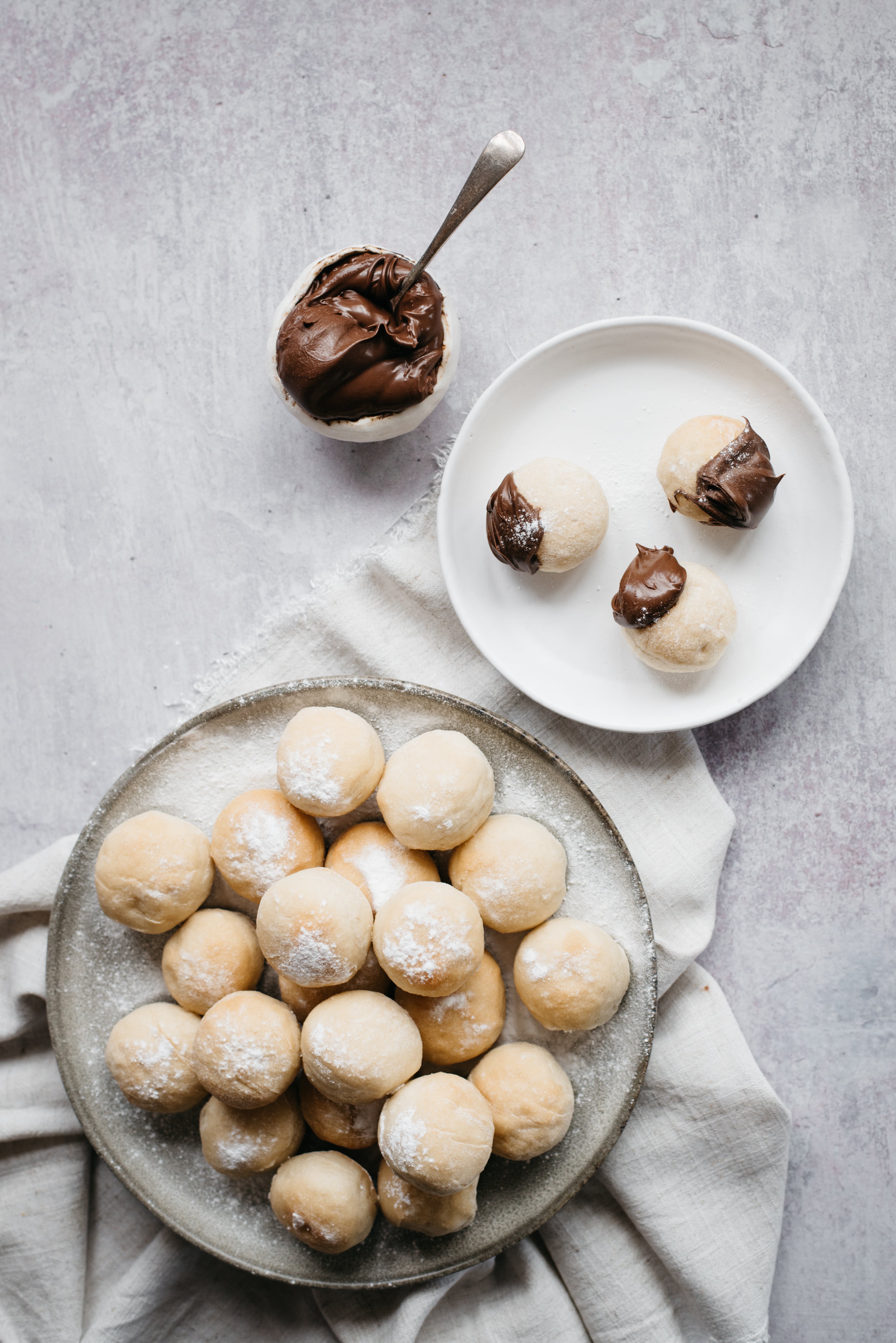 Top view of Chocolate Dough Balls, served on a plate with dough balls dipped in chocolate sauce