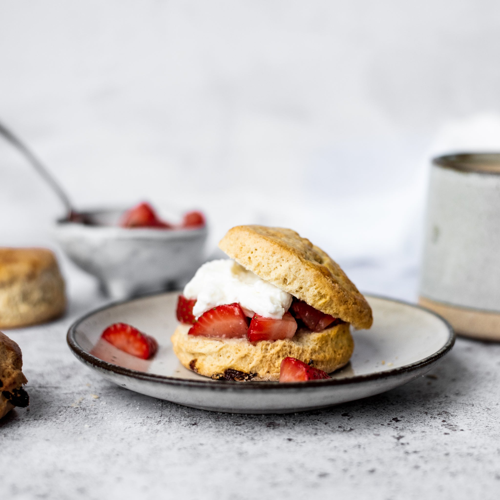 scone with strawberries and cream on a plate 