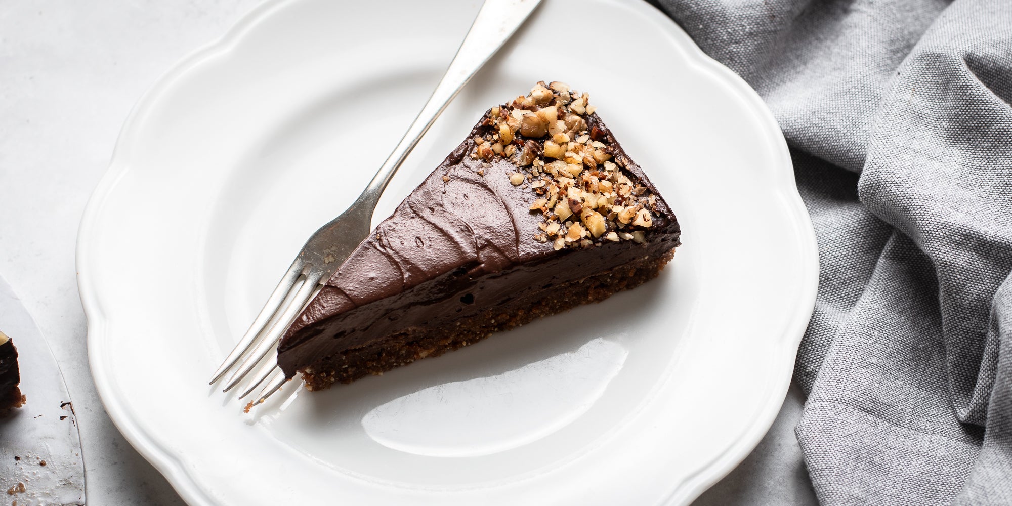 Raw Chocolate Avocado Cheesecake slice on a plate next to a fork