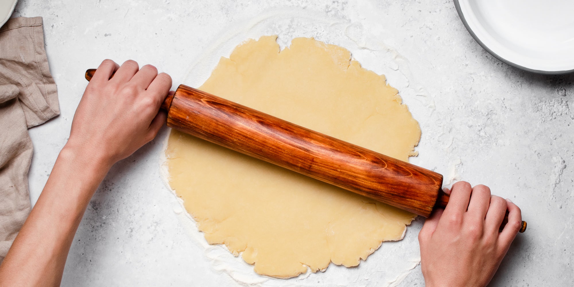Shortcrust pastry being rolled out onto a floured surface