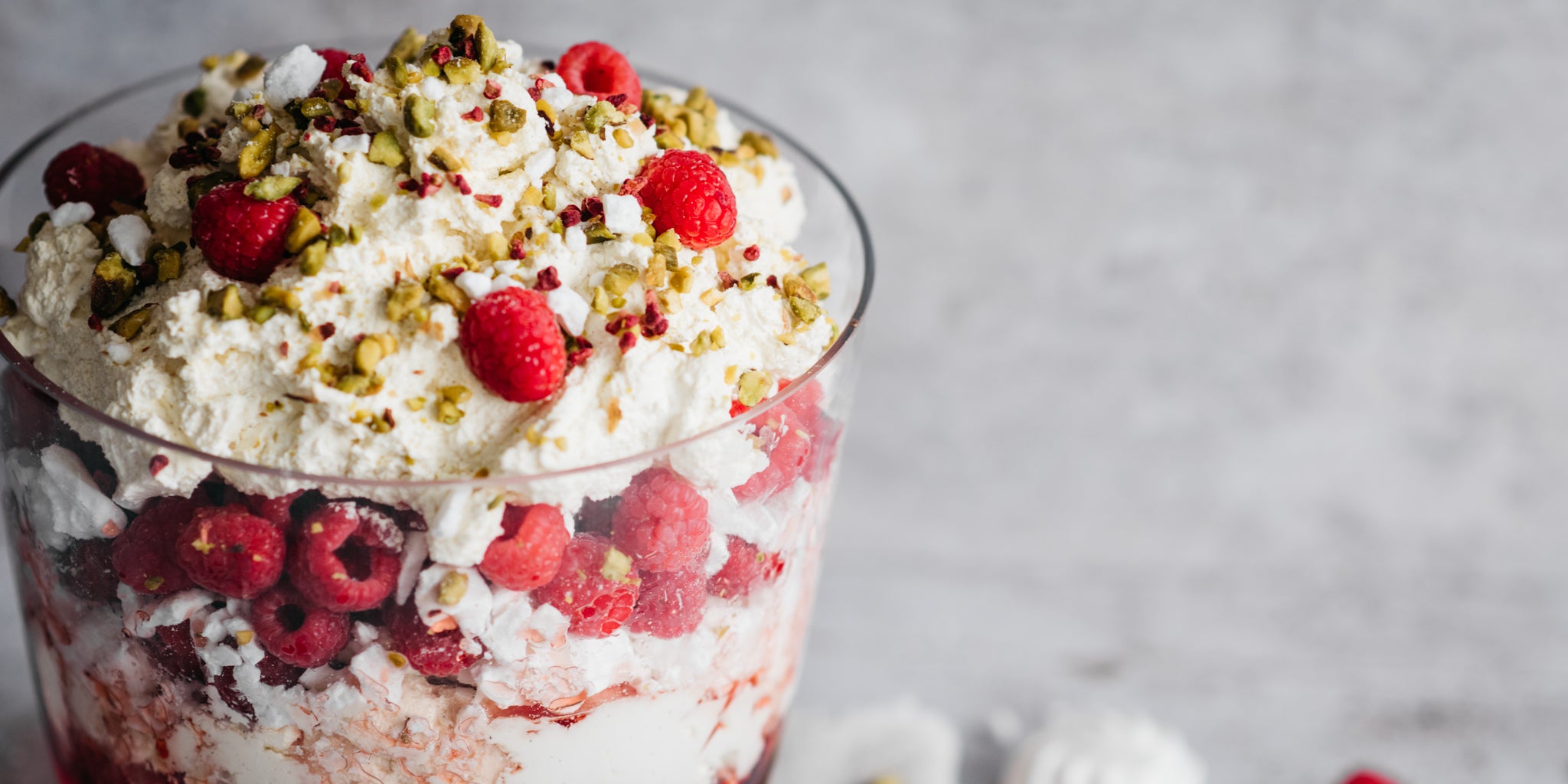 Close up of Eton Mess Trifle topped with raspberries and chopped nuts