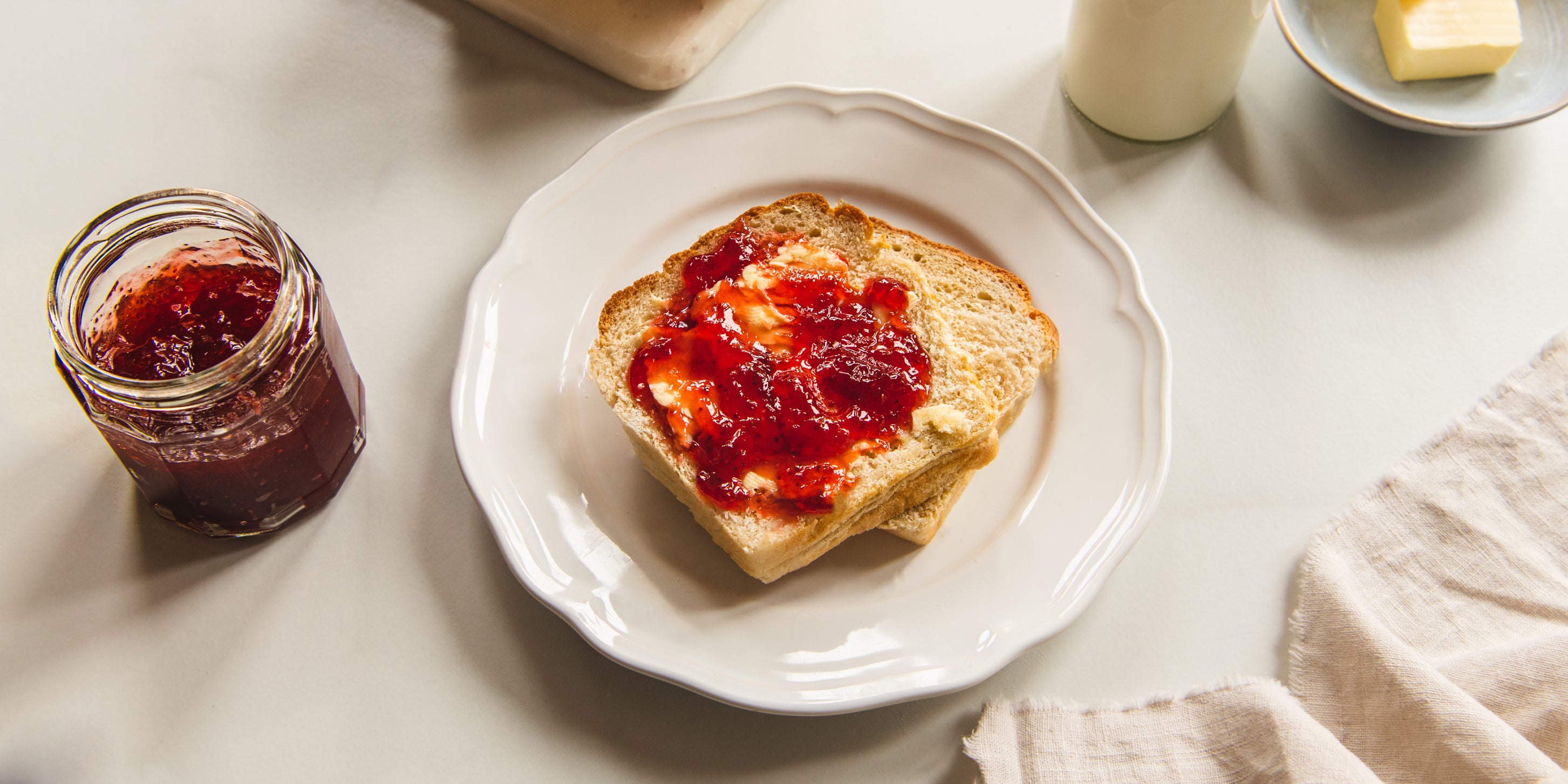 Shokupan Milk Bread slices with a spread of butter and jam