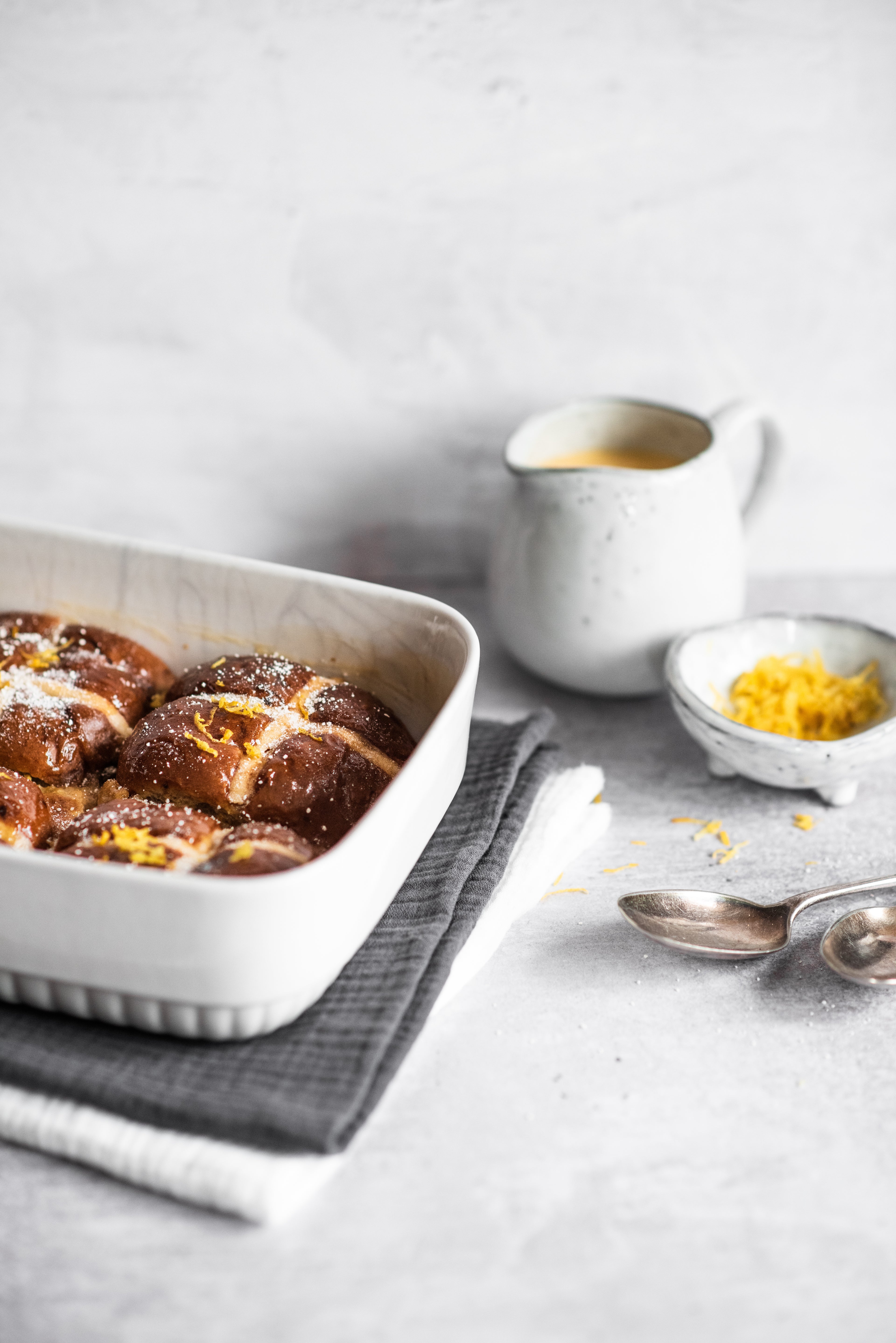 Four Hot Cross Bun Bread Butter Puddings in a tray