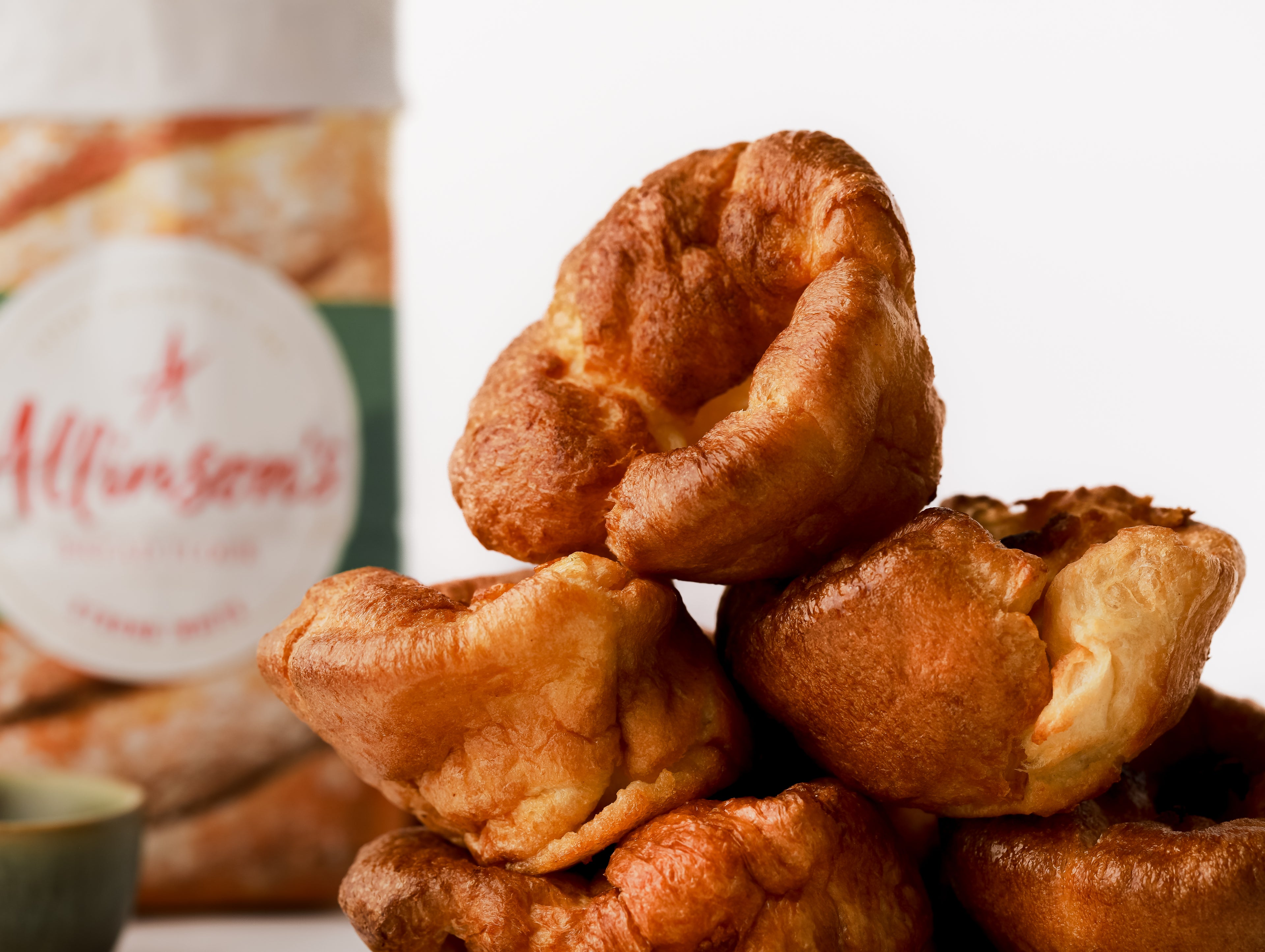 Stack of yorkshire puddings with a bag of flour in the background