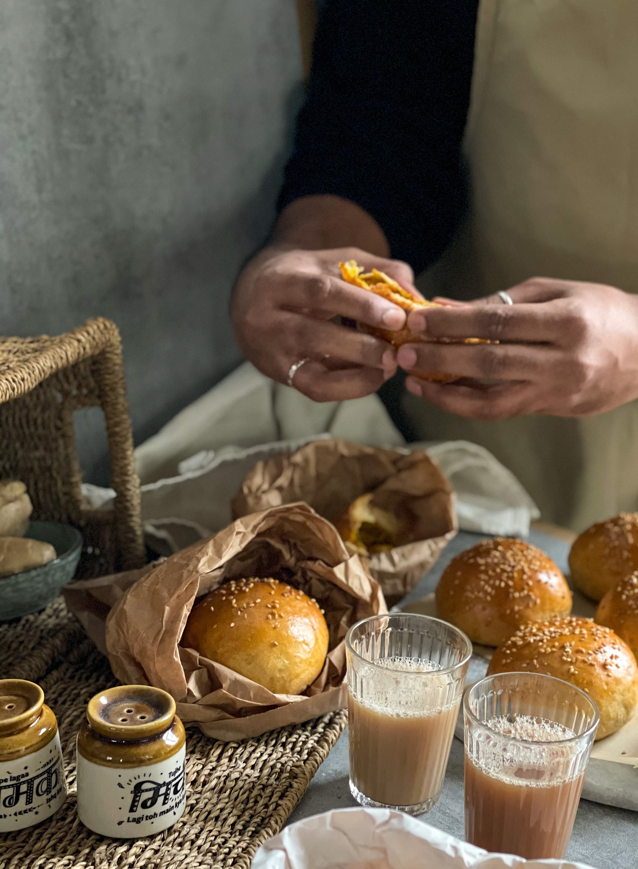 4 seeded bread buns, hands pulling apart 1