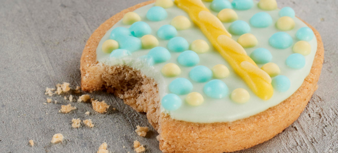 Close up of an iced easter biscuit with a bite taken out of it