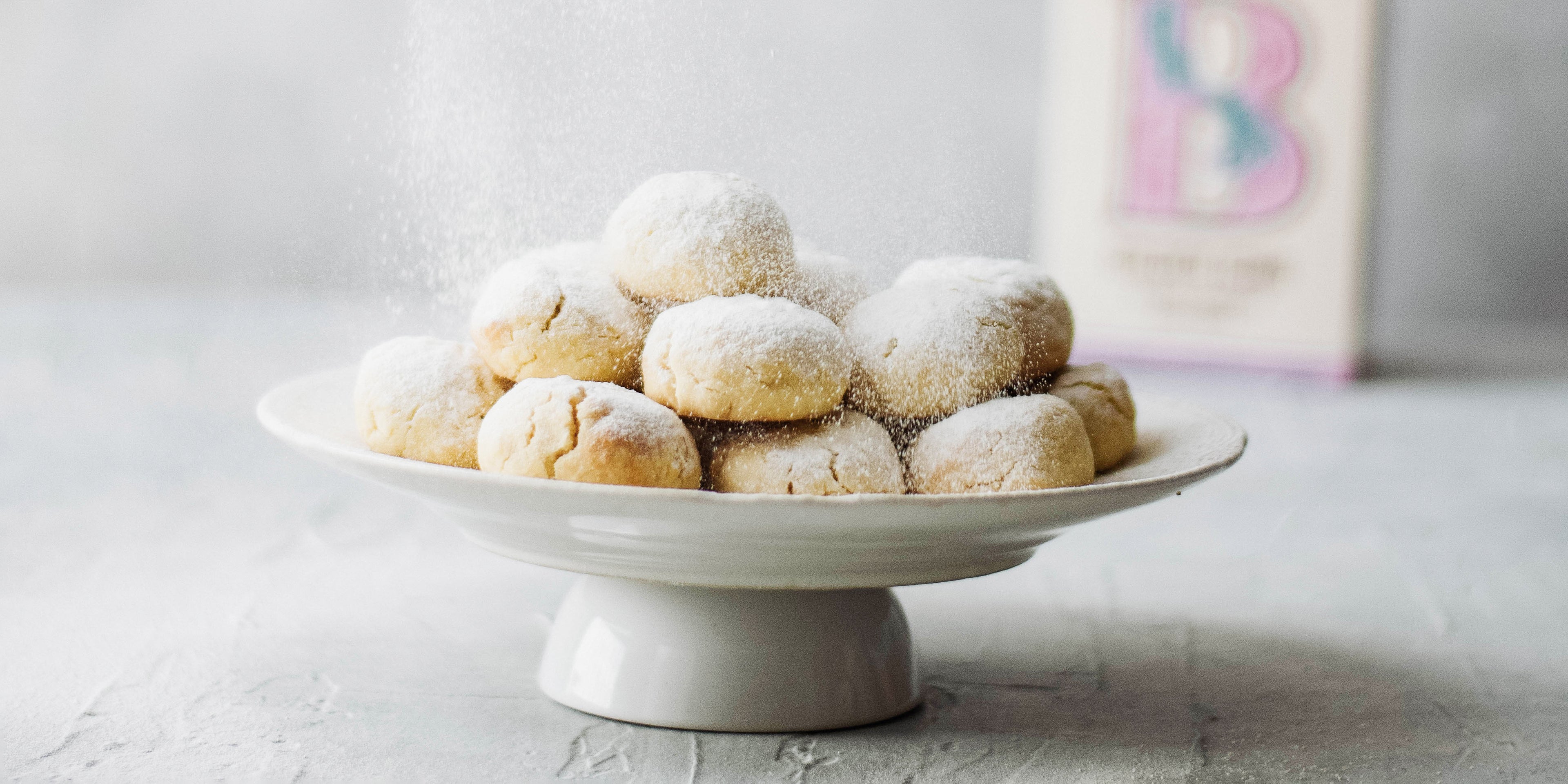 Kahk Eid on a cake stand, dusted with icing sugar