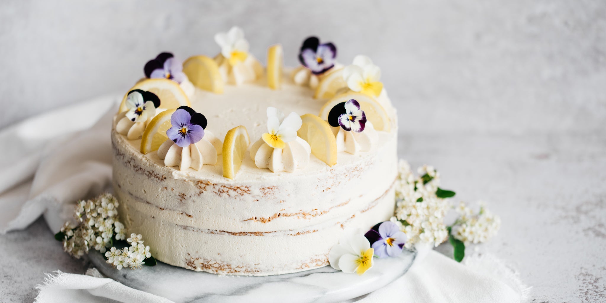 Cake topped with flowers on a marble board