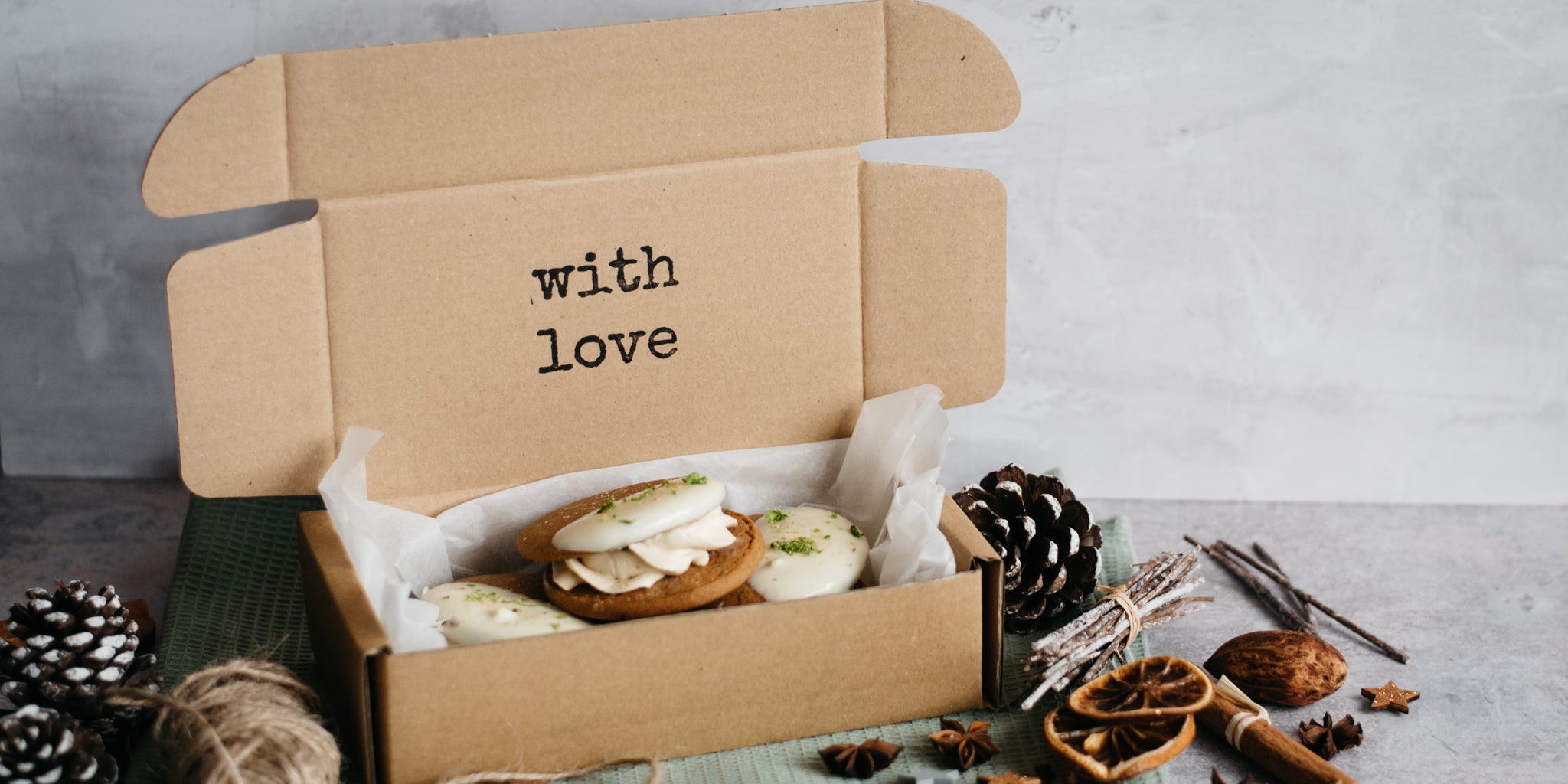 Close up of Citrus Gingerbread Cookies in a gift box with parchment paper and 'with love' printed on it. 