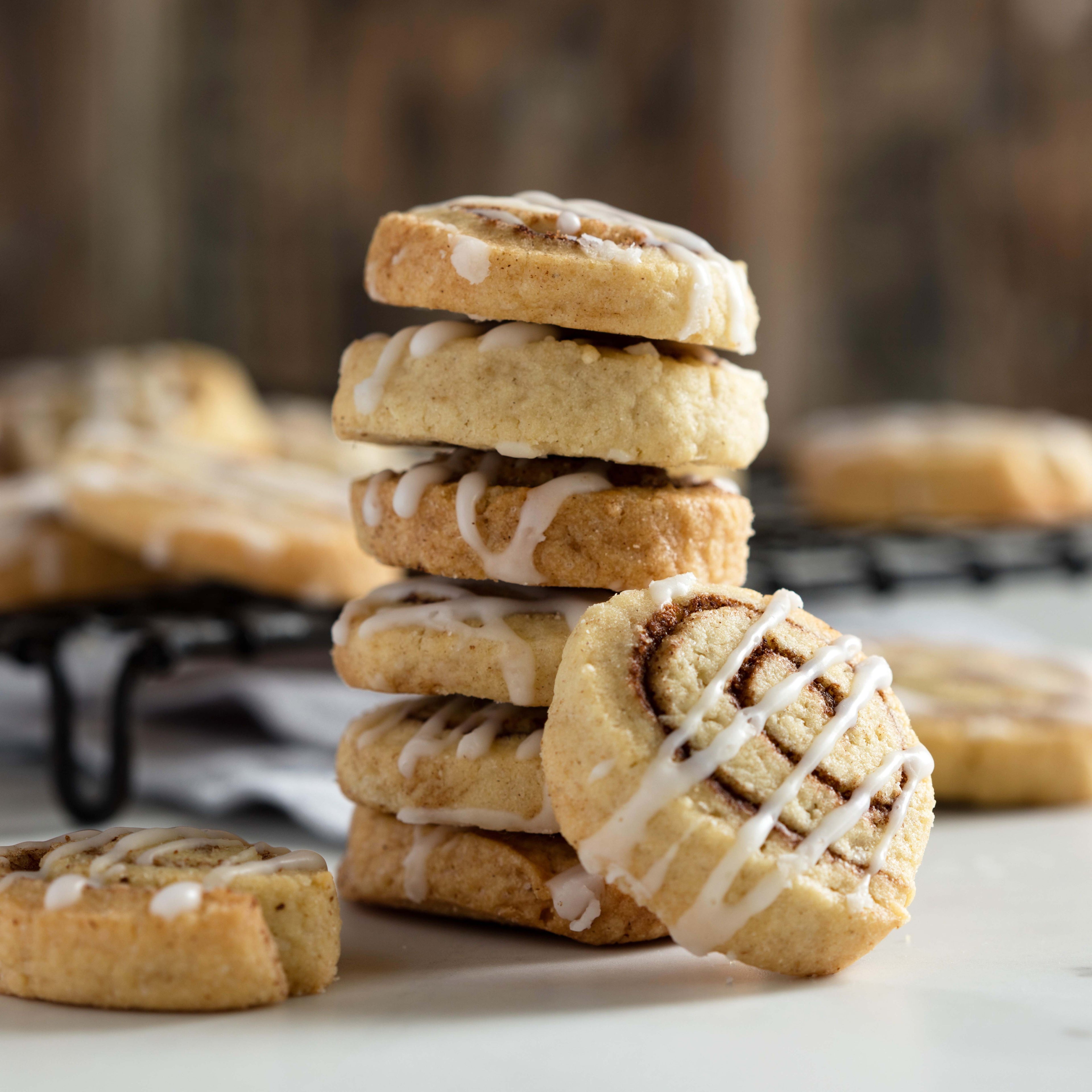 Cinnamon Roll Biscuits stacked on top of each other with one propped on the side