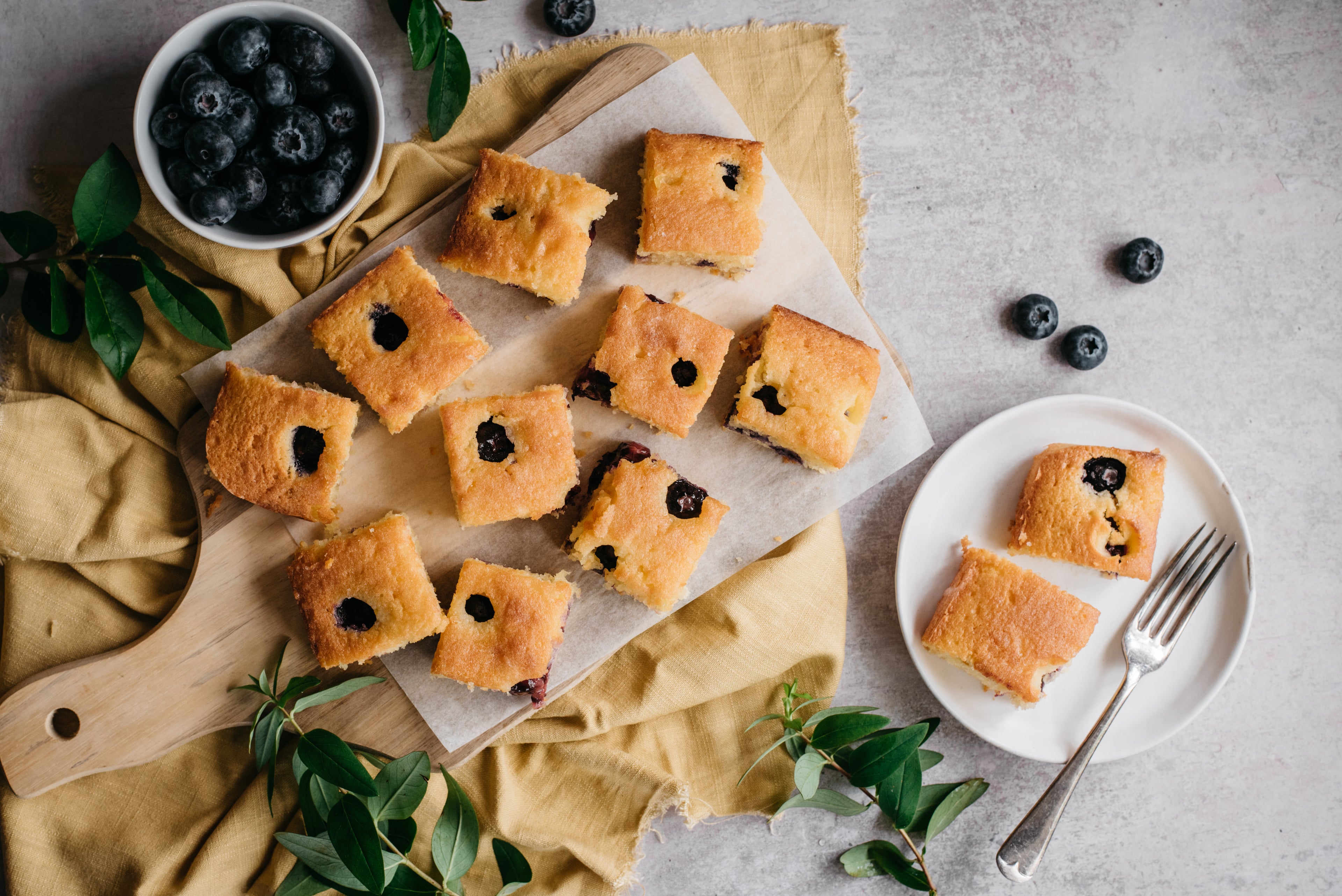 Top down view of low sugar lemon and blueberry traybake