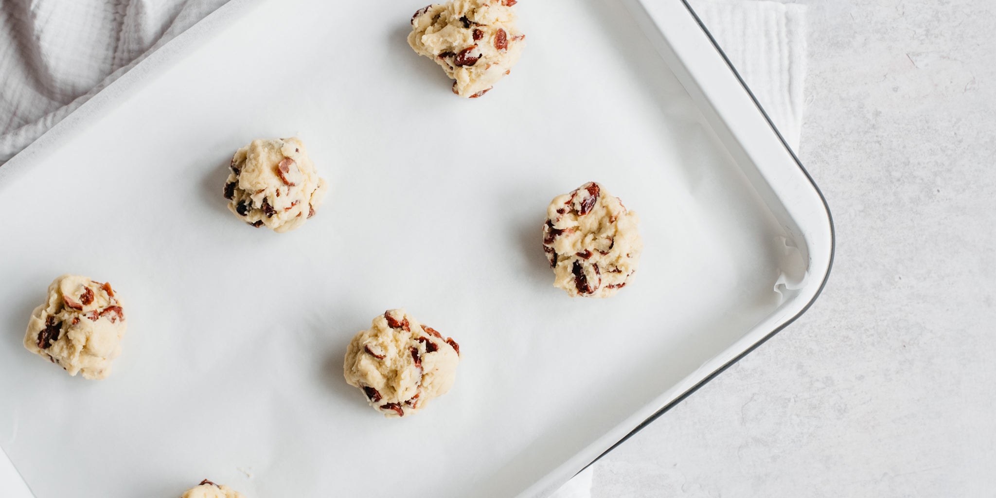 Baking tray with raw rock bun mixture in small balls on top