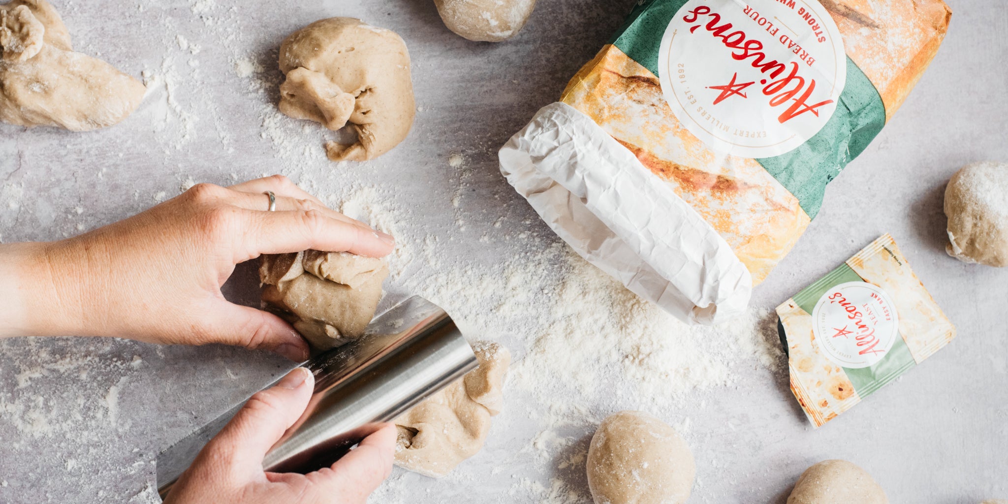 Dough cut into balls with open flour pack next to it