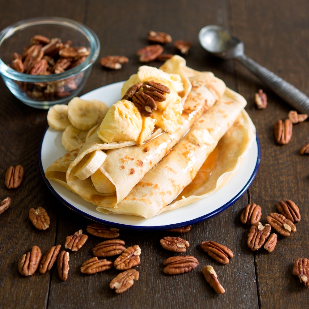 Banana pancakes with slices of banana and vanilla ice cream