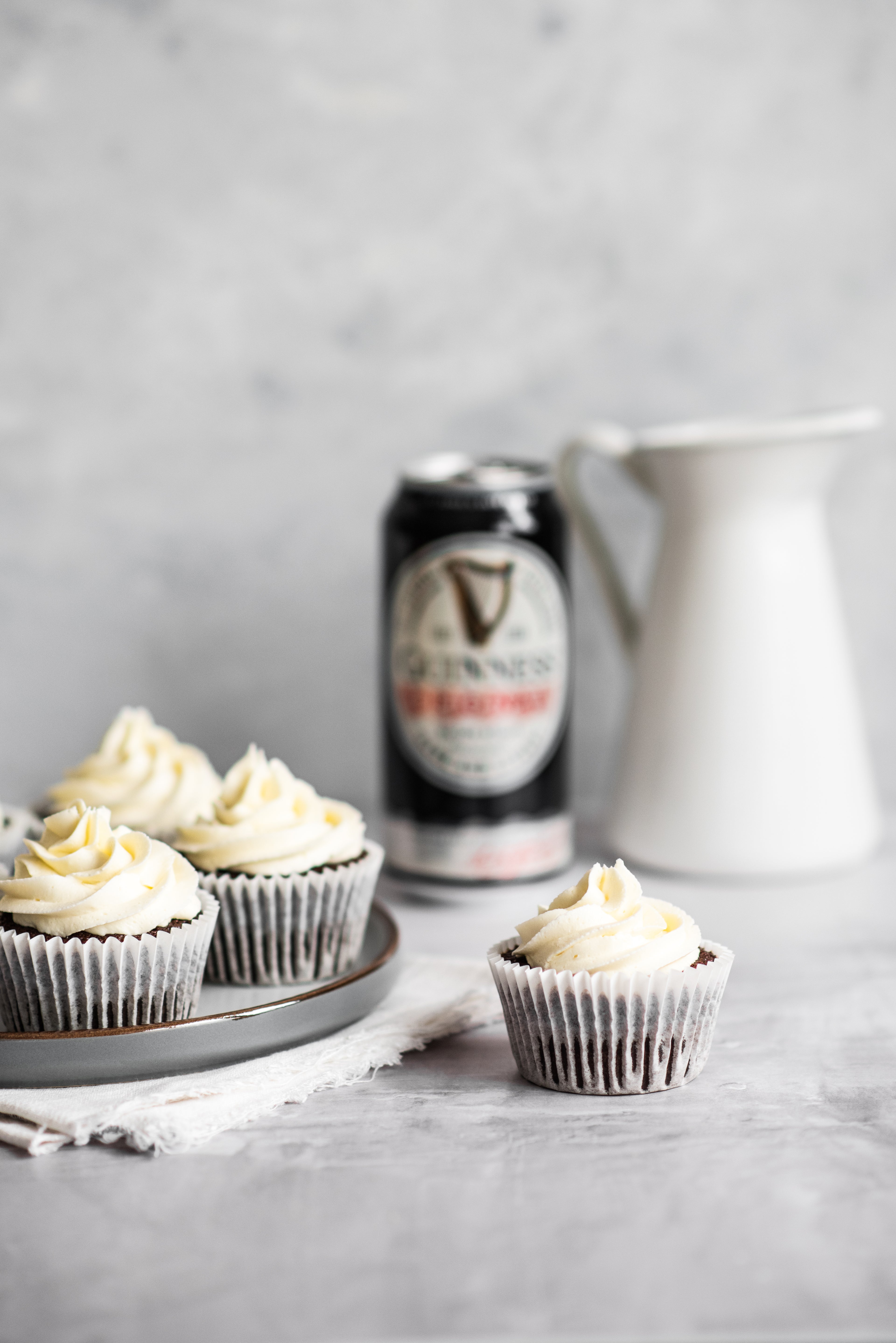 Cupcake centre of image with Guinness in the background