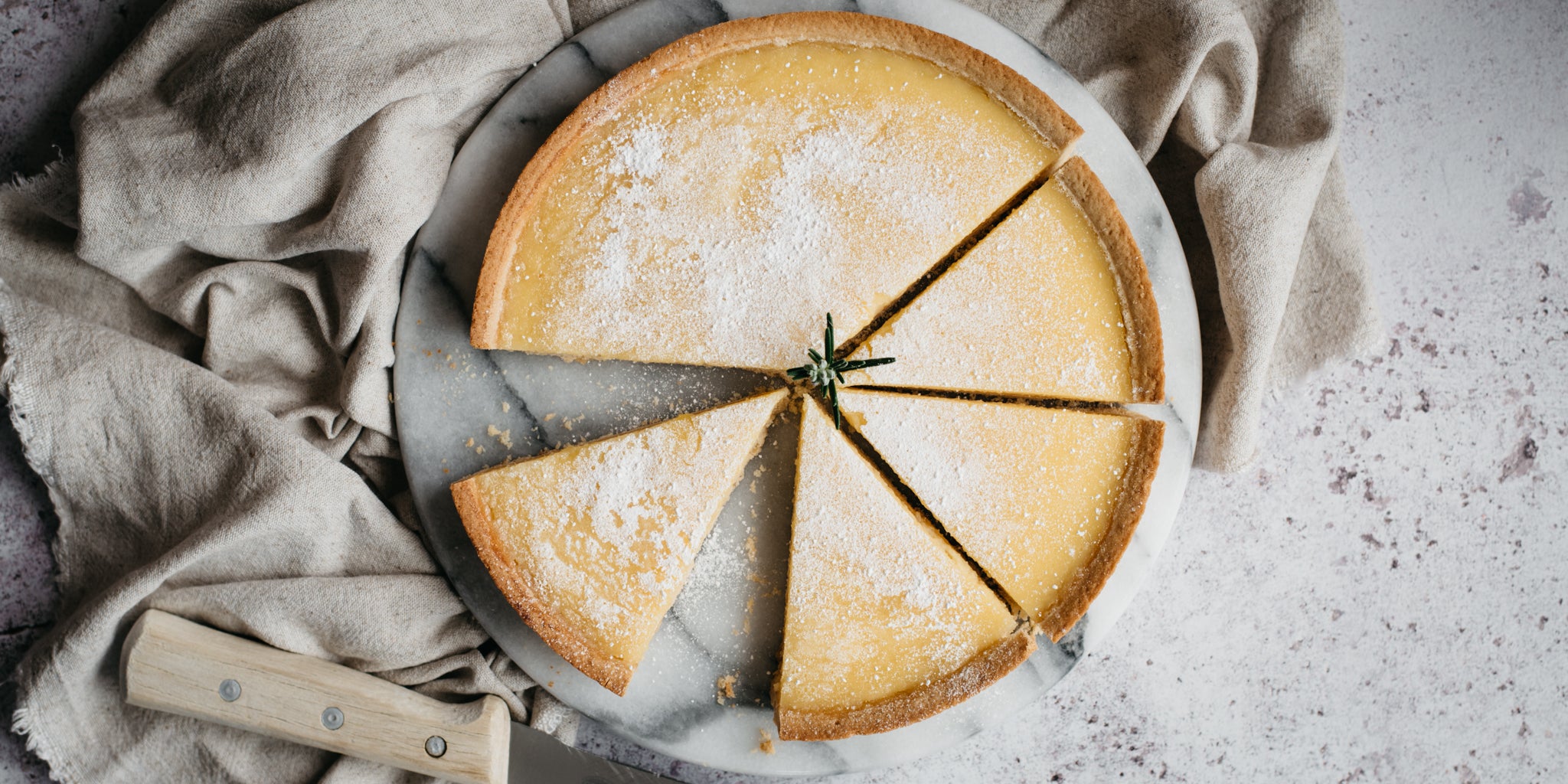 Top view of Lemon Tart sliced into servings and dusted with Silver Spoon Icing Sugar