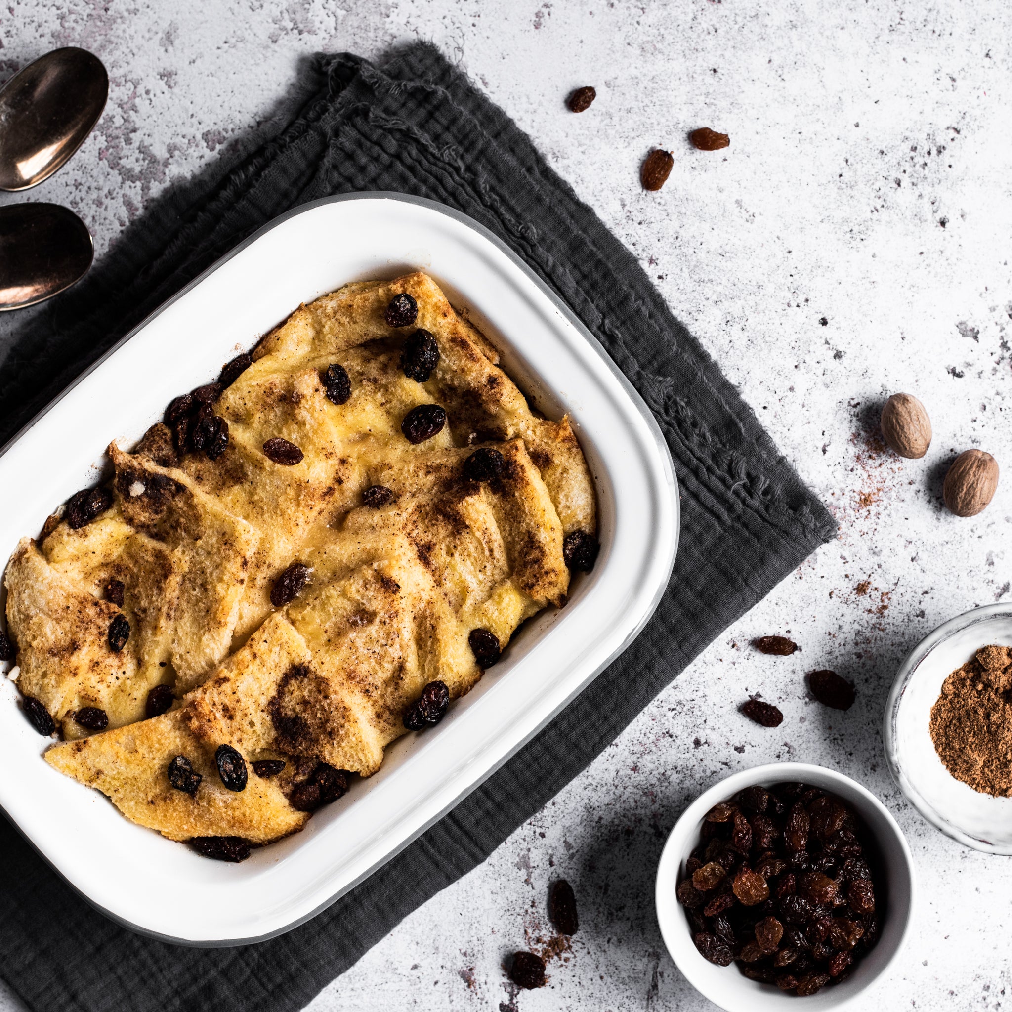 Bread and butter pudding in a tin with raisins