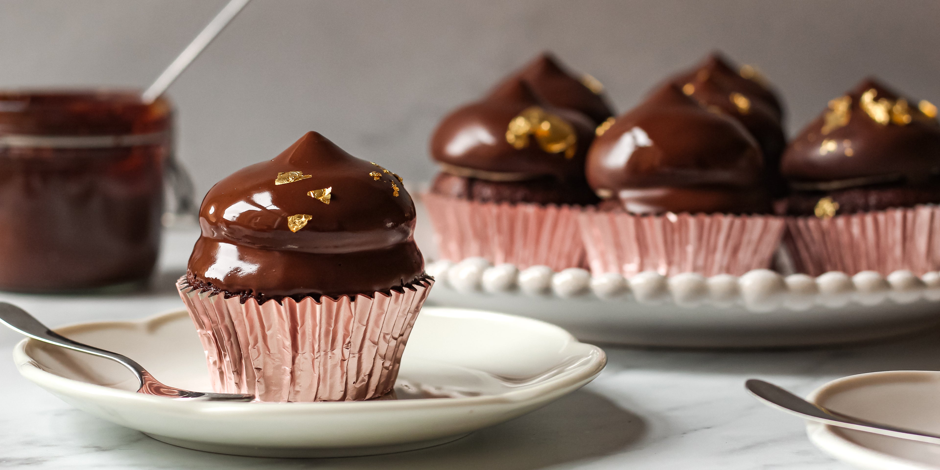 Close up of Hi-Hat Cupcakes coated in glossy chocolate drip