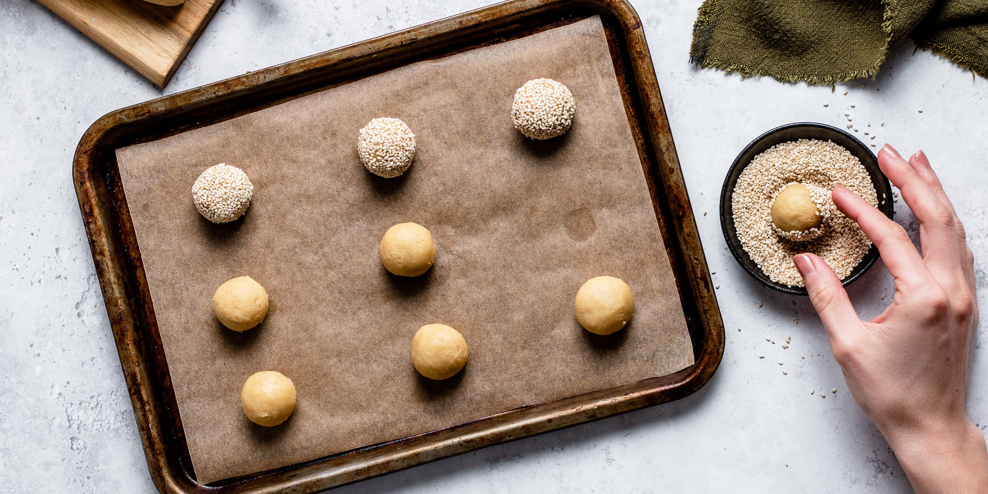 Top down view of raw sesame cookie dough on a baking tray