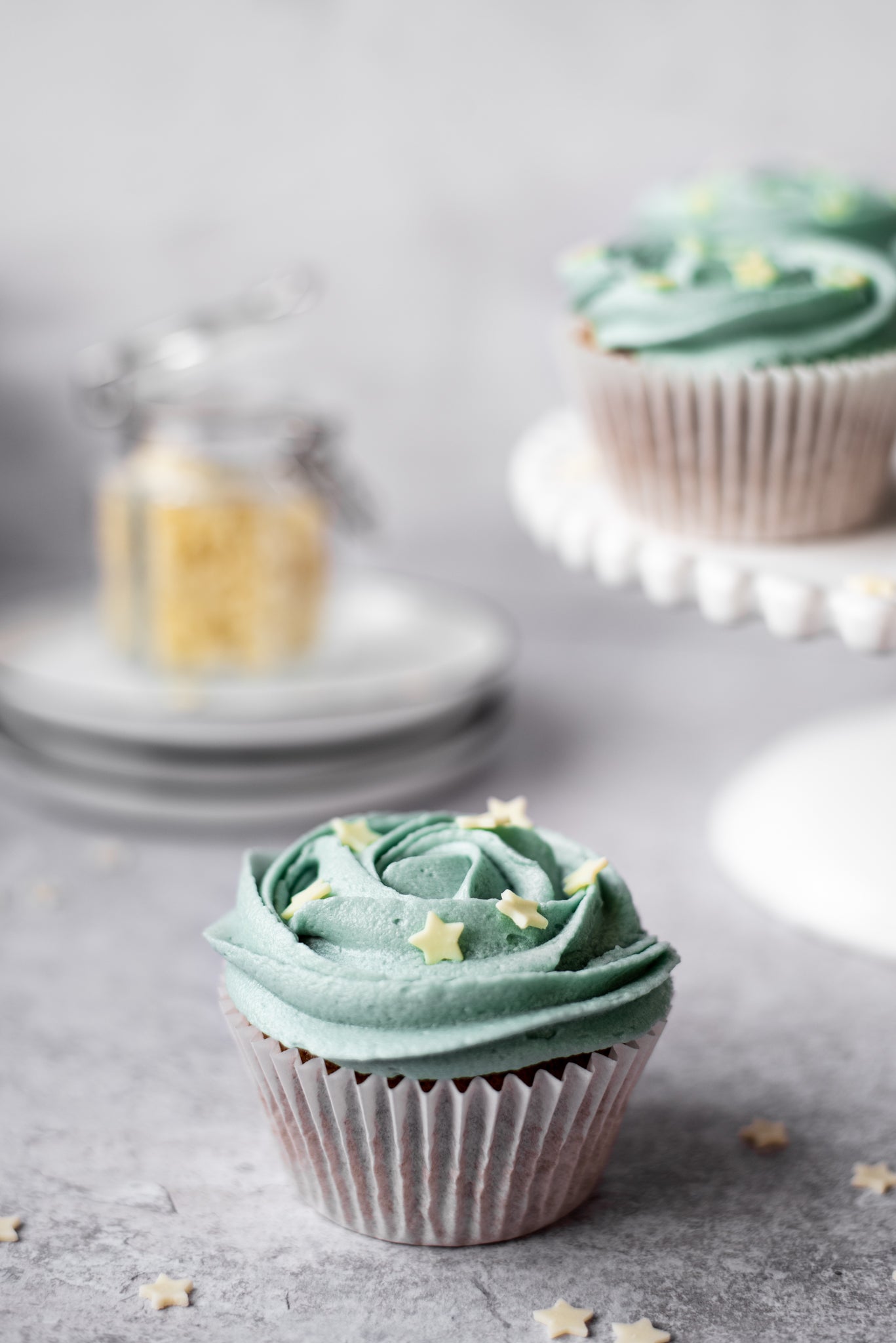 Earl Grey cupcakes decorated with buttercream on a grey worksurface 