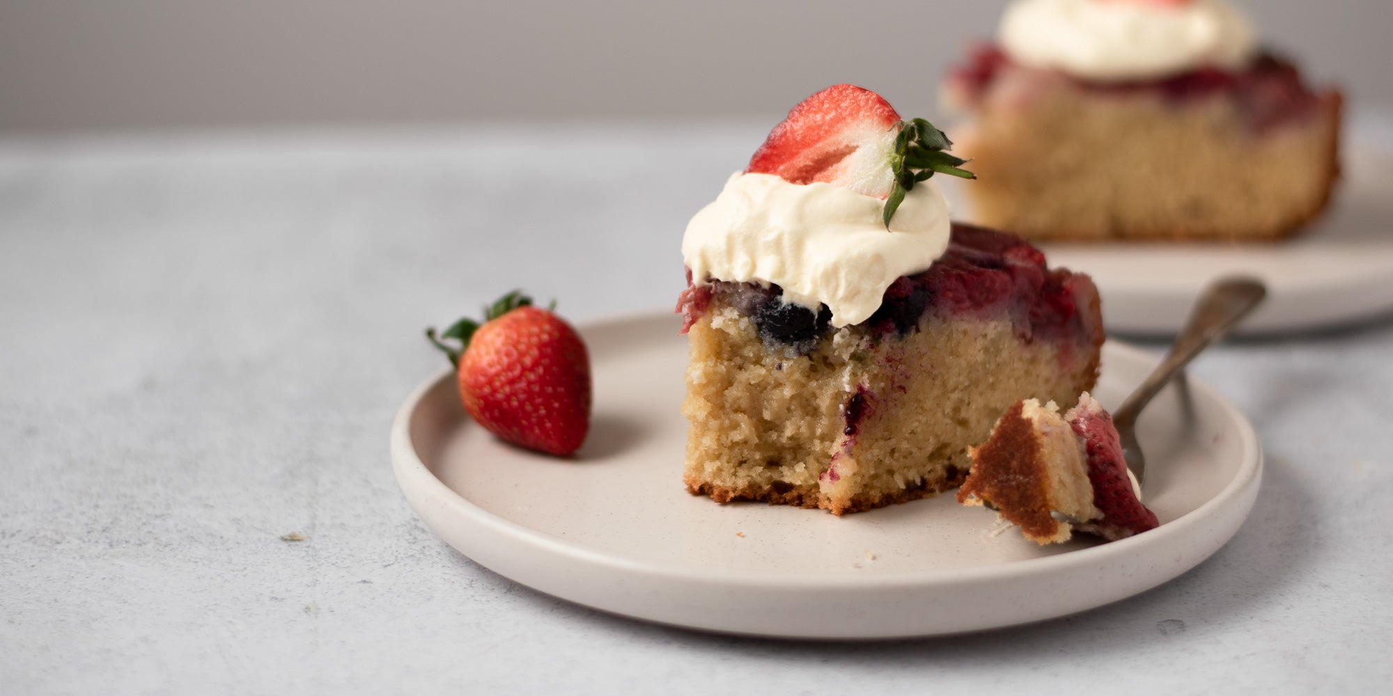 slice of upside down berry pudding on a plate