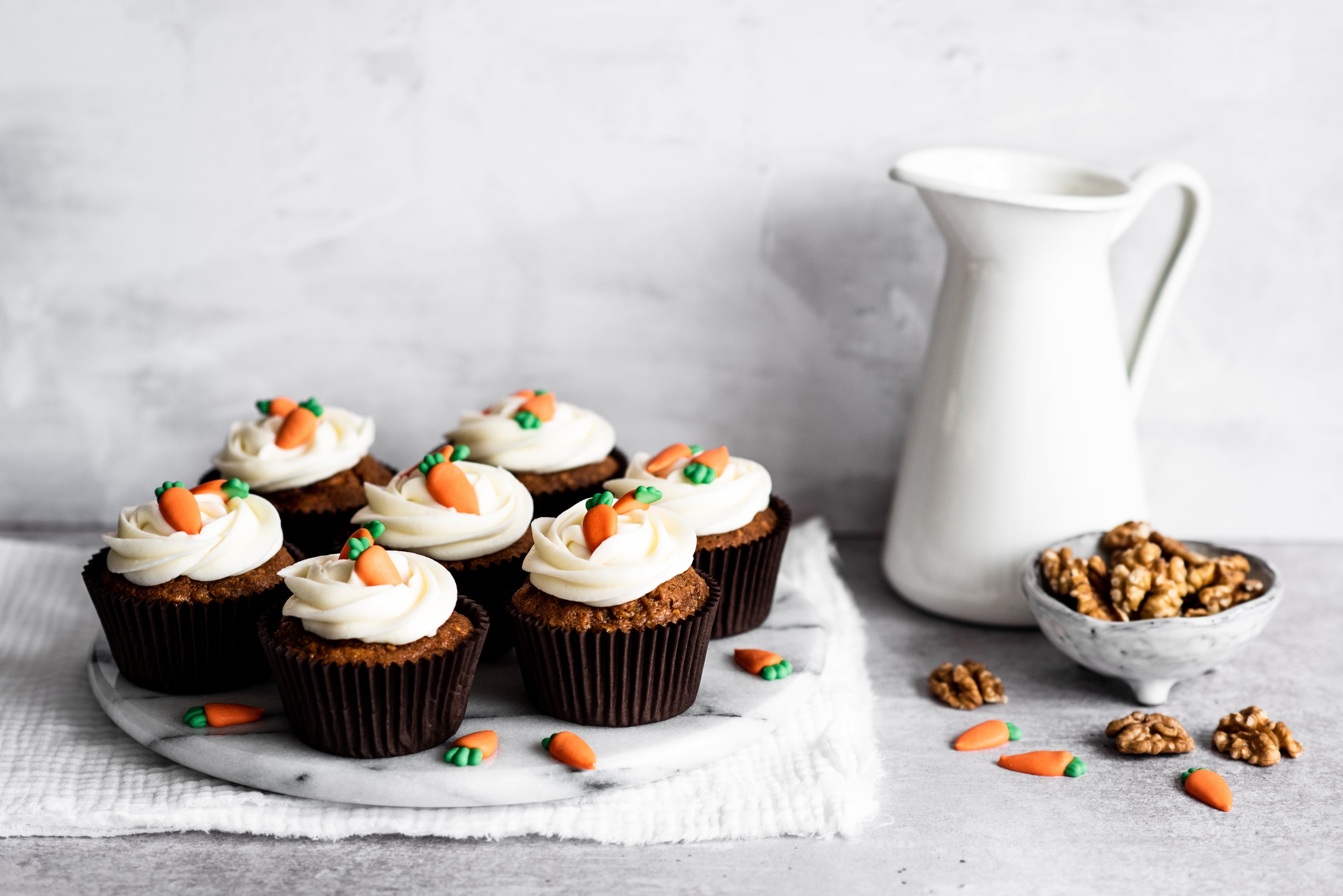 Carrot cake cupcakes with cream cheese icing and carrot decorations