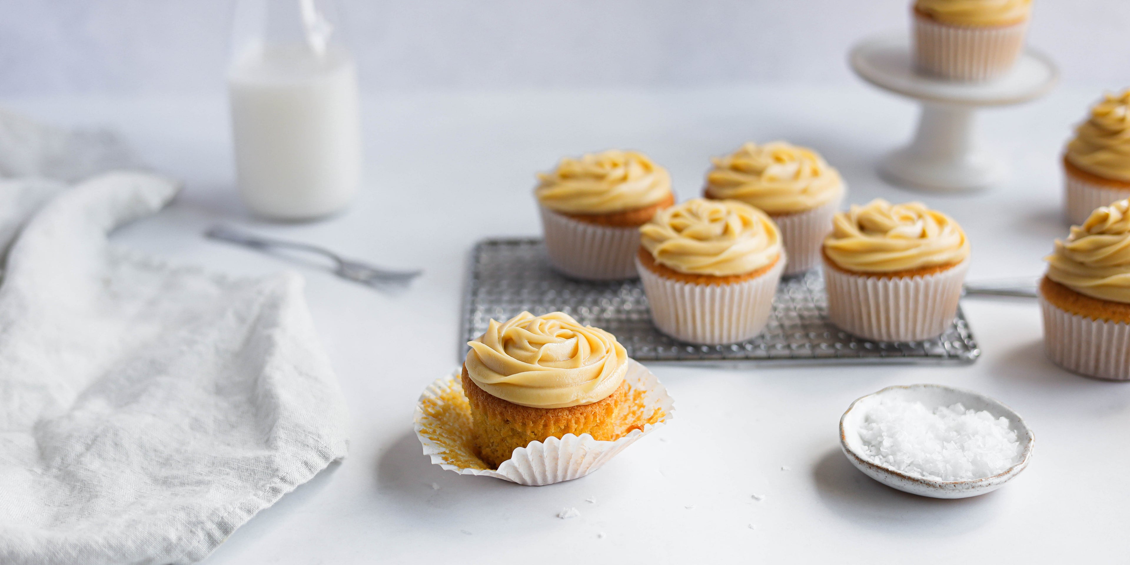 Salted caramel cupcakes cooling on a wire rack