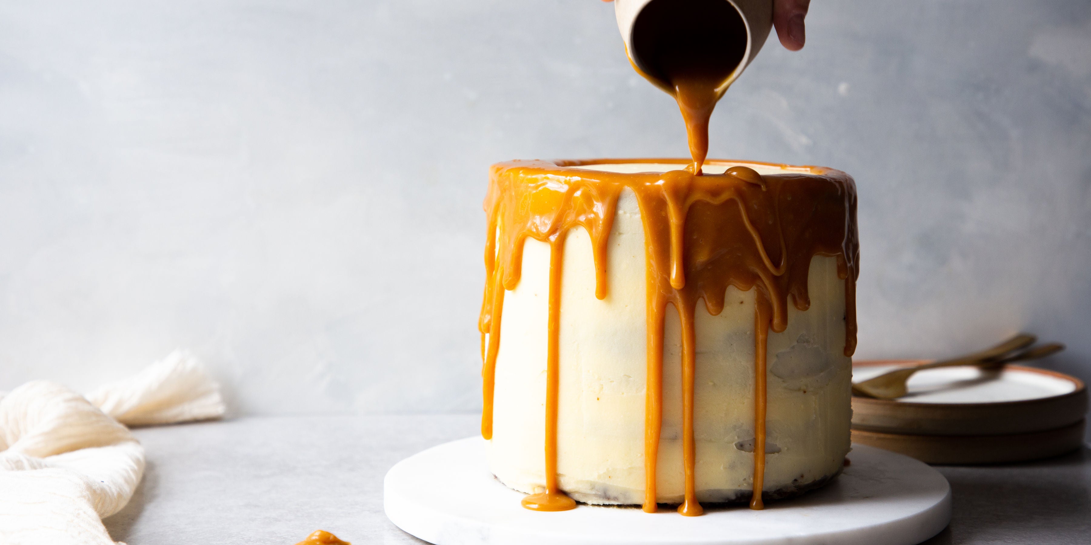 Gingerbread Birthday Cake being drizzled with caramel sauce