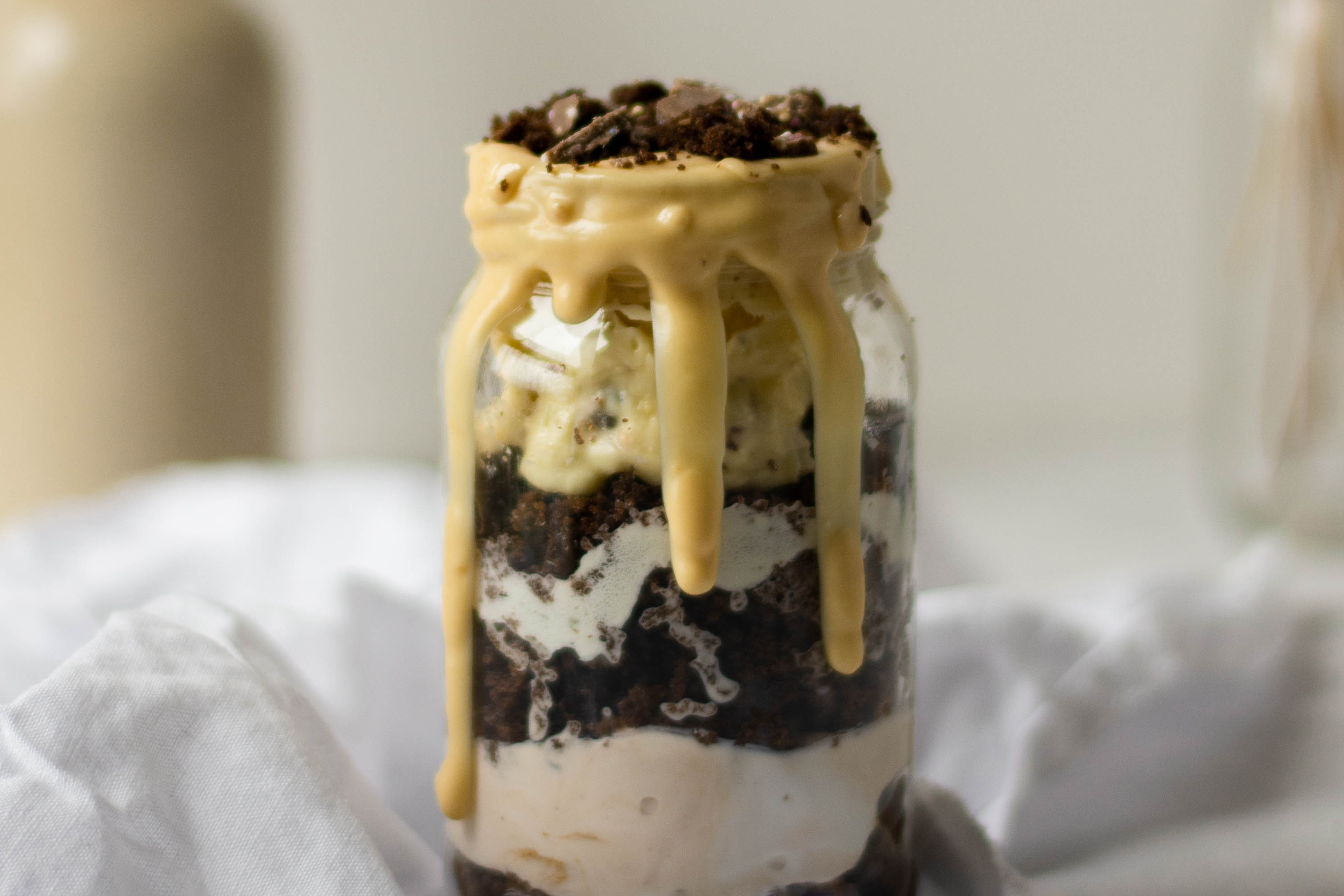 Bailey Jar Cake close up, with chocolate dripping down the jar. Layers of chocolate cake, and Bailey buttercream