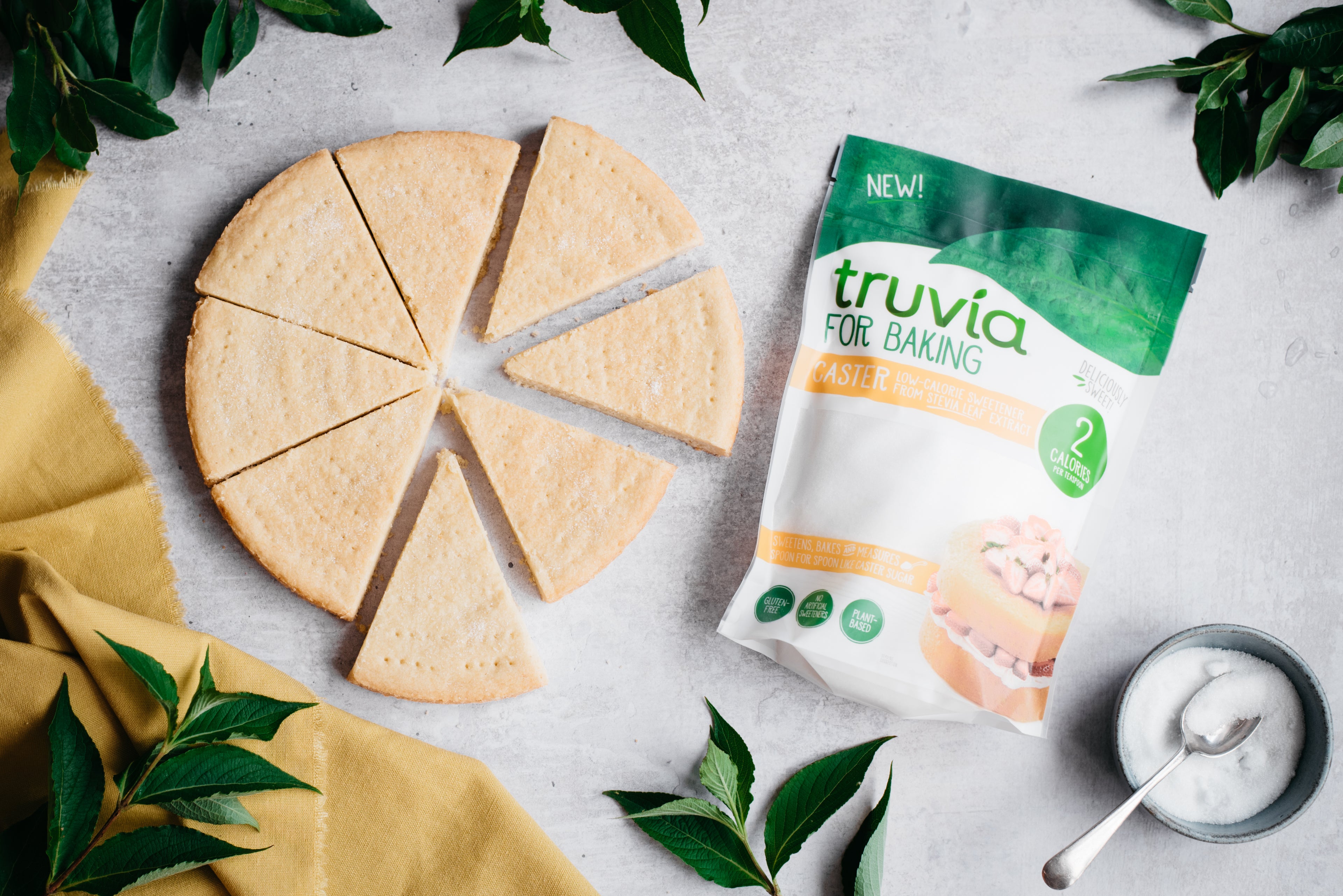 Top down view of a batch of healthy shortbread next to a bag of truvia for baking caster sugar