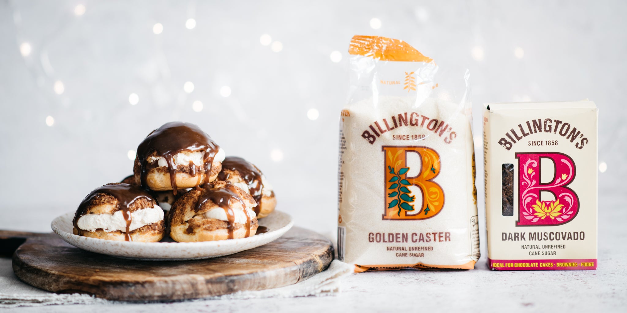 Plate of profiteroles beside two sugar packs