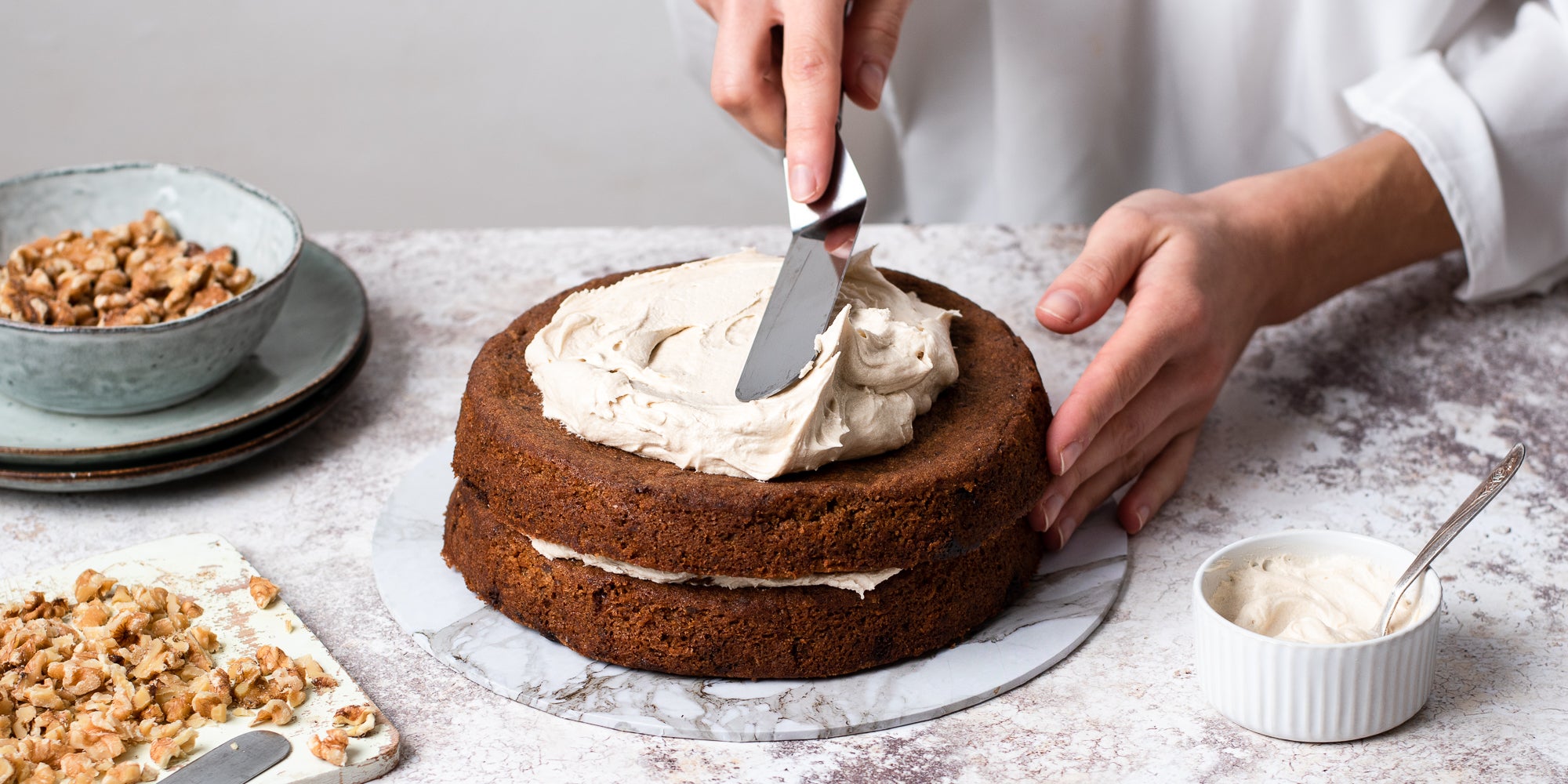 Gluten Free Vegan Coffee Cake being hand finished with buttercream