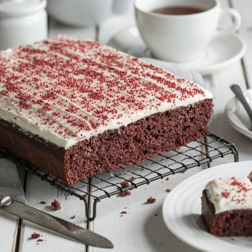 Red velvet traybake with cream cheese icing and red sprinkles