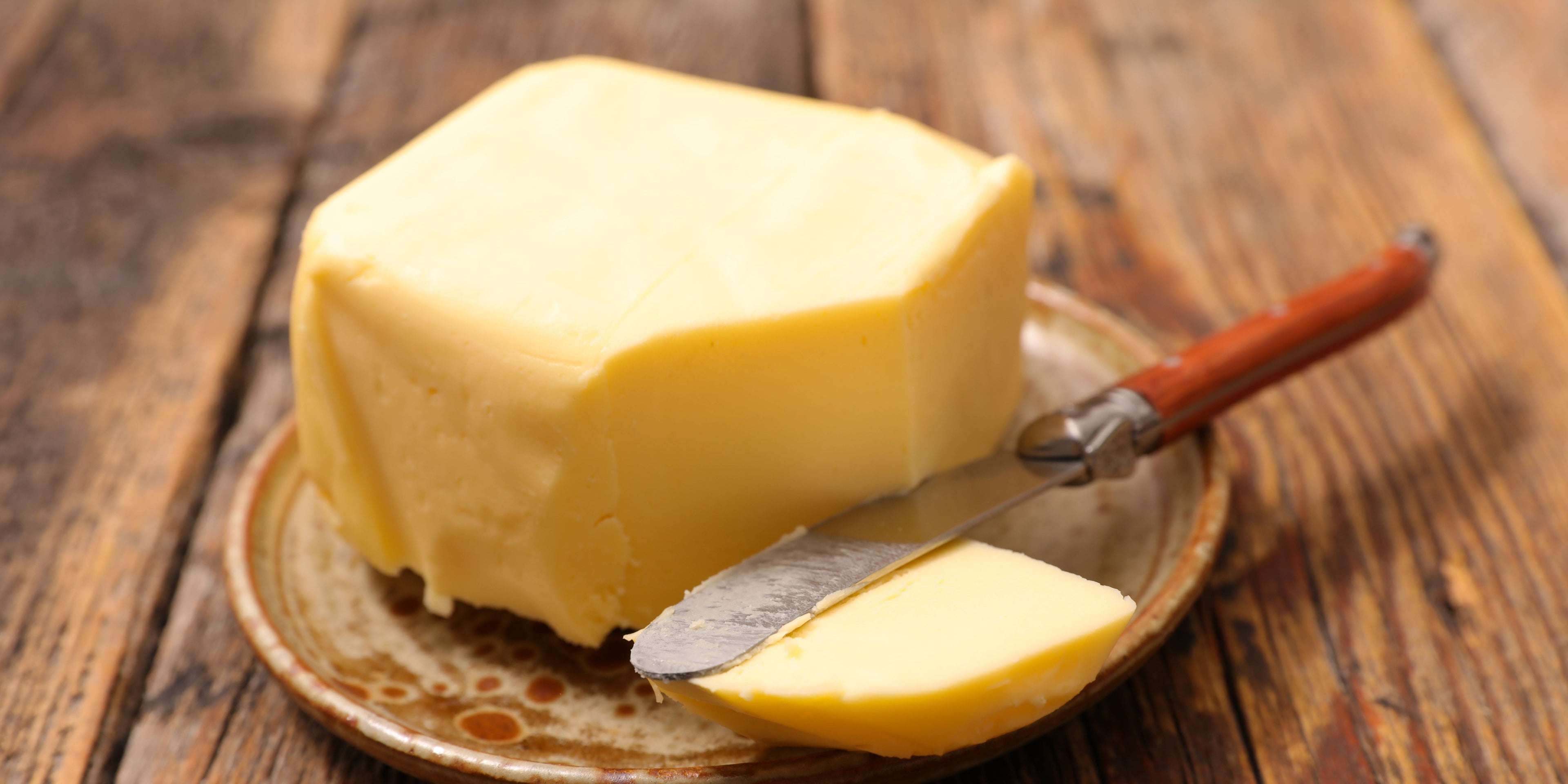 Pat of butter on a brown earthenware plate