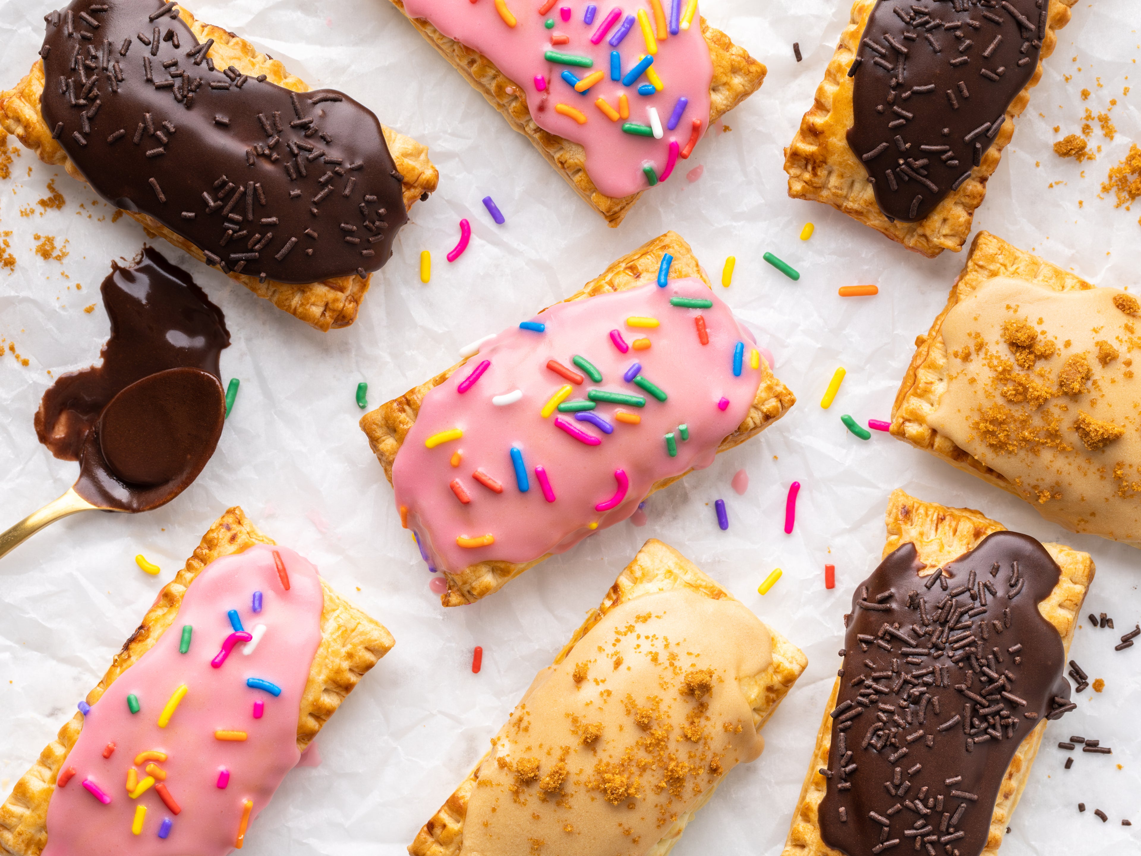 Pop tarts decorated with biscoff, chocolate and pink icing with sprinkles. 