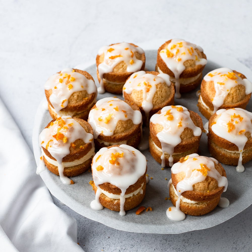 mini orange sponge cakes with glace icing on top 