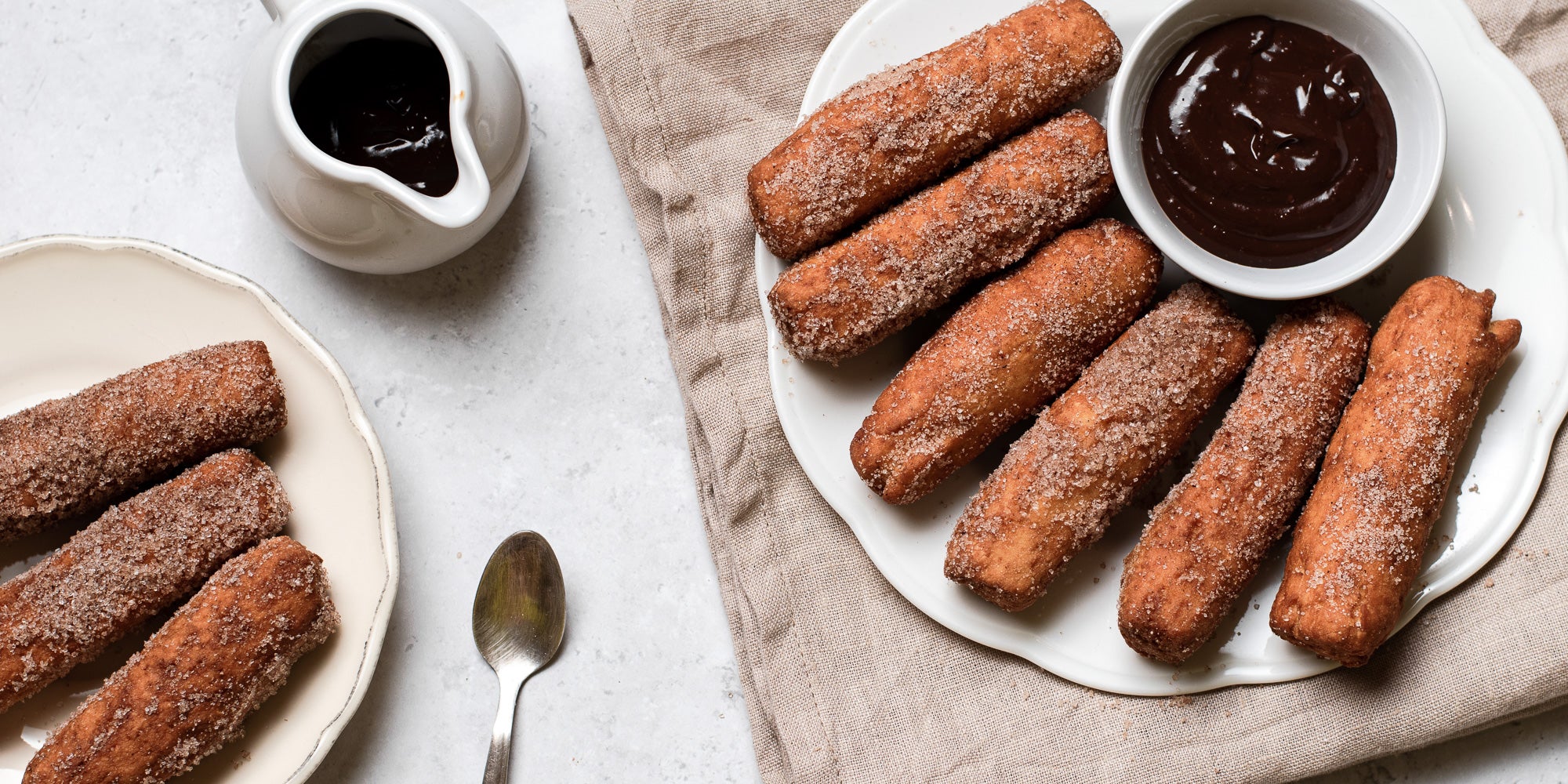 Doughnut Sticks with Chocolate Dip flat lay, with a spoon next to a jug of chocolate dip 