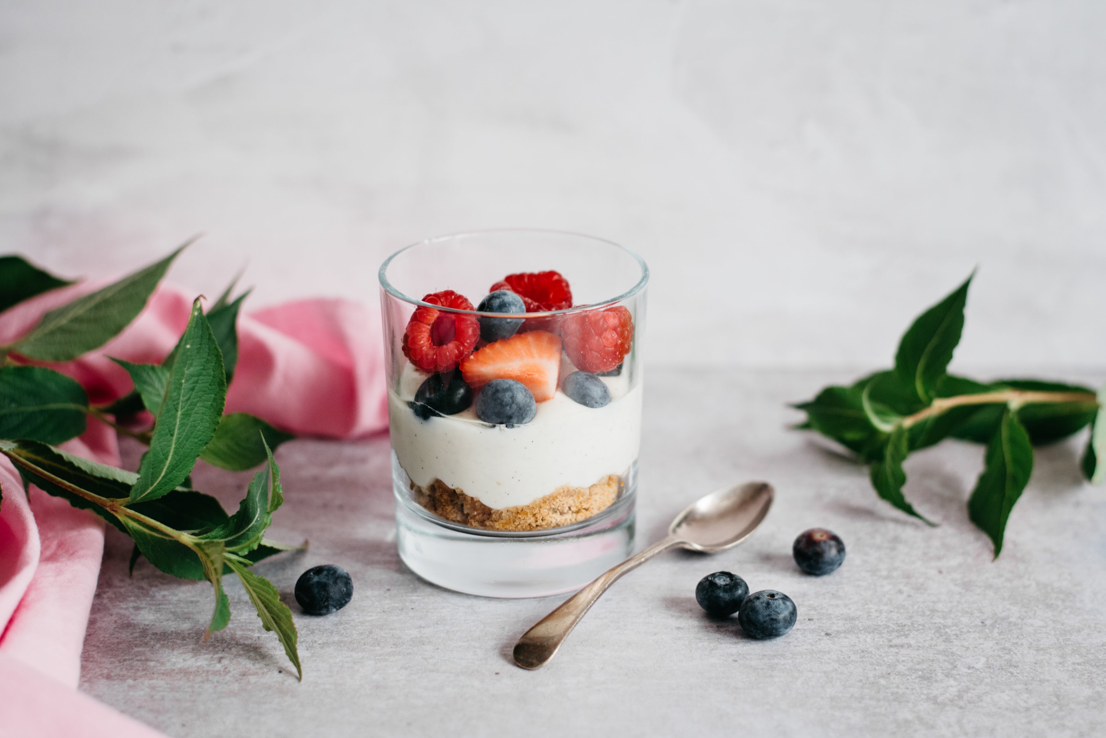 A no bake honey and berry cheesecake in a glass