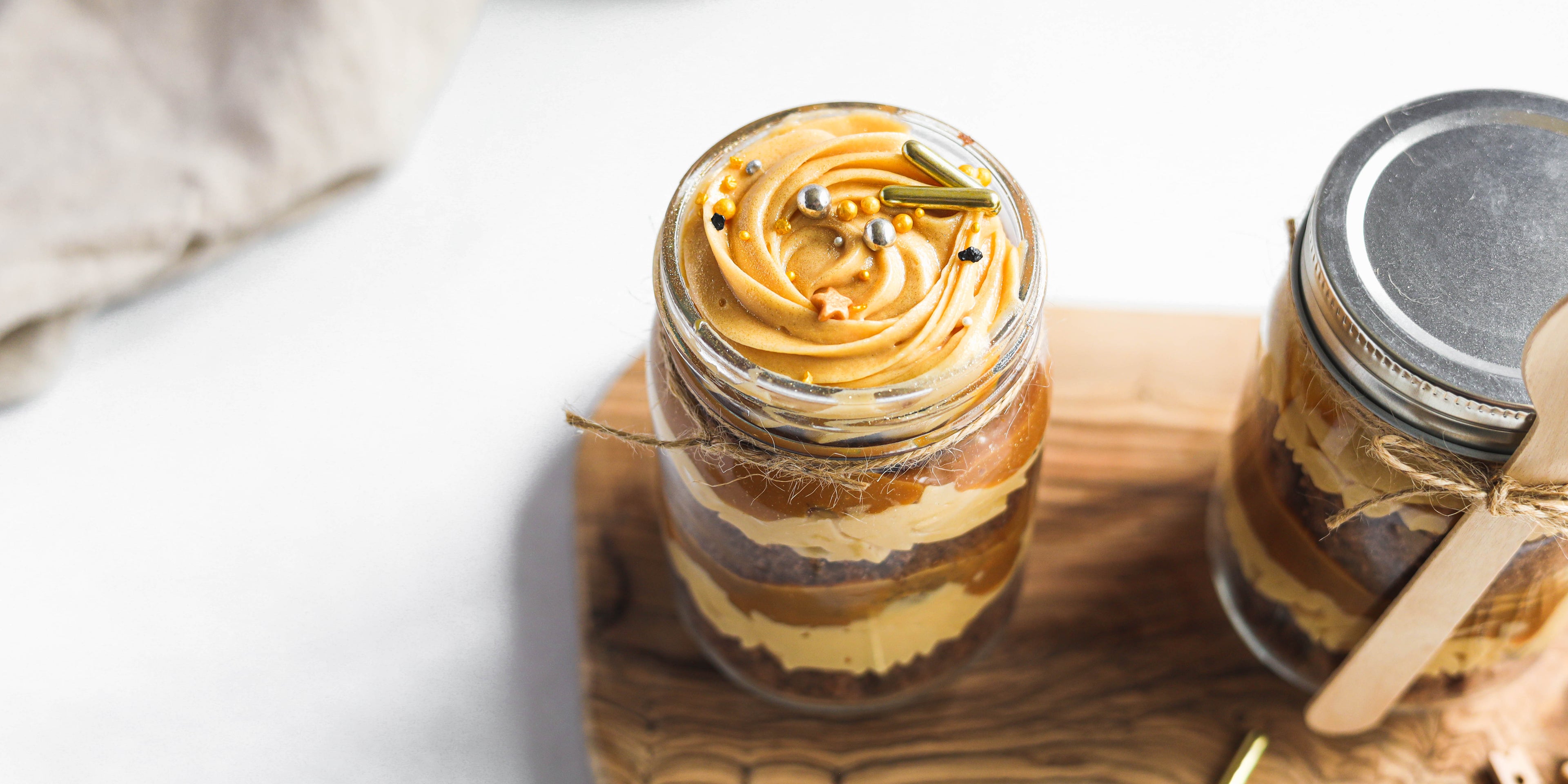 Chocolate & Salted Caramel Cupcakes in a Jar with swirl of buttercream on top, with sprinkles