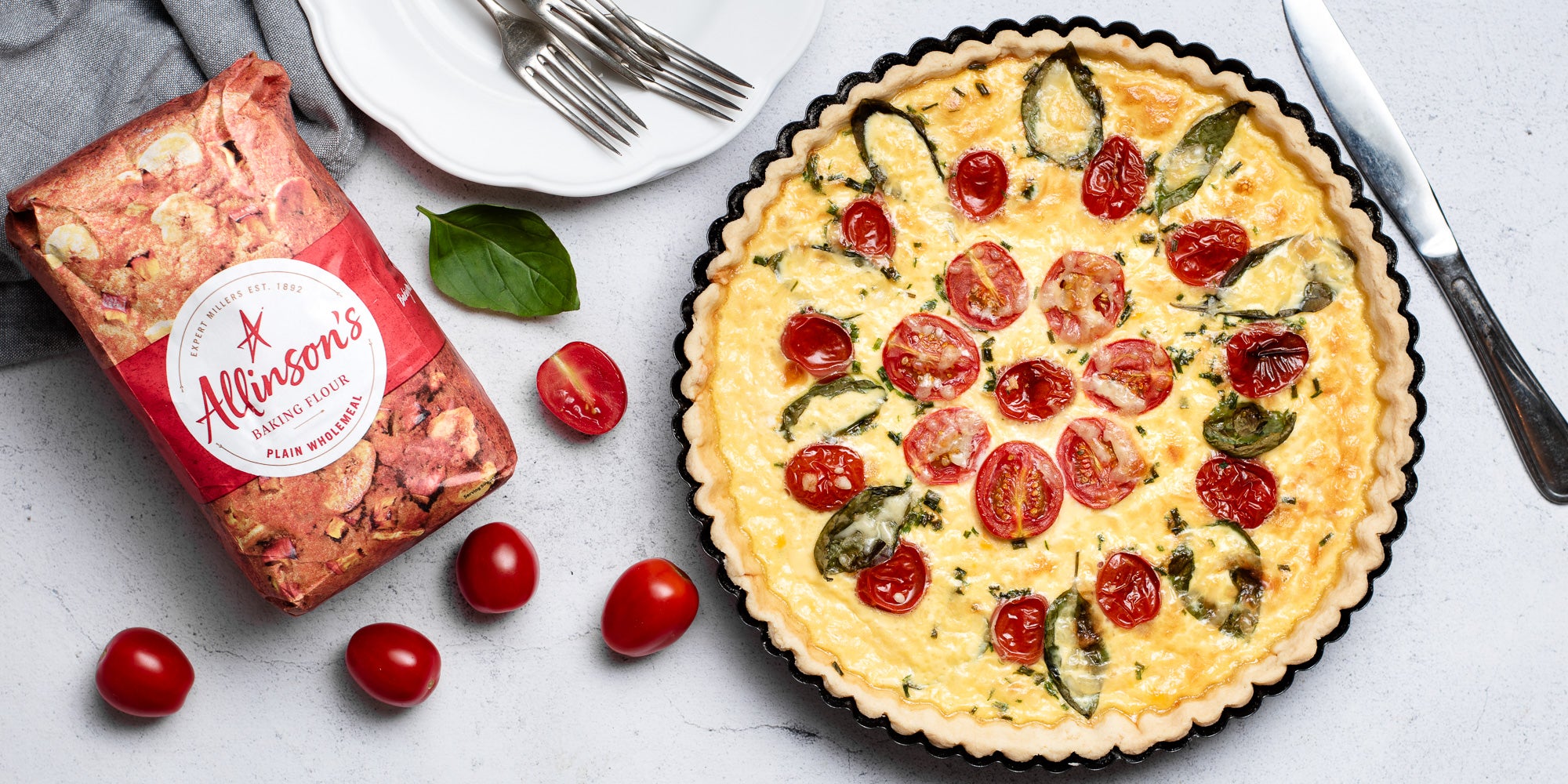 Cheese & Tomato Quiche with a bag of Allinson's Plain Wholemeal flour and chopped tomatoes