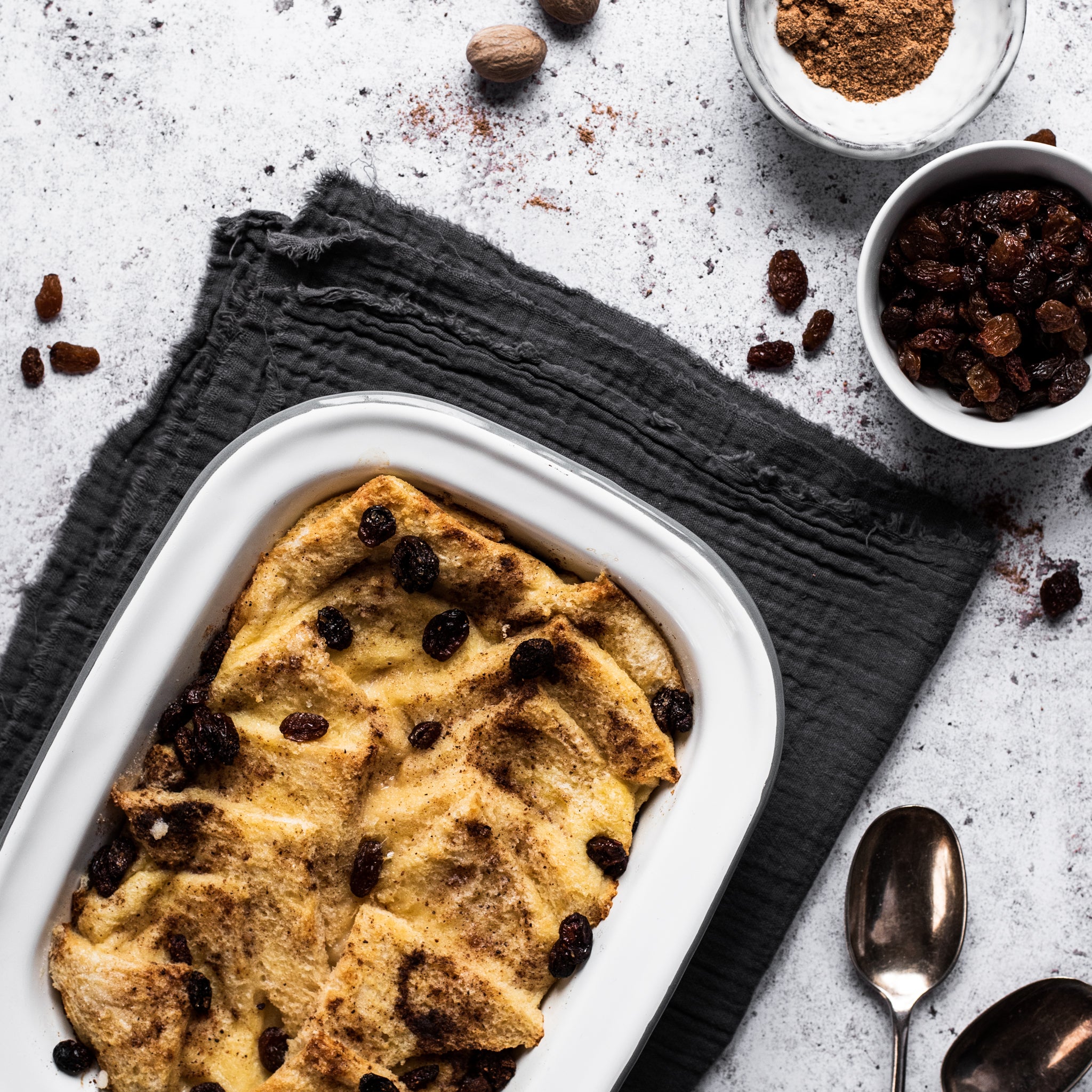 Bread and butter pudding in a tin with raisins