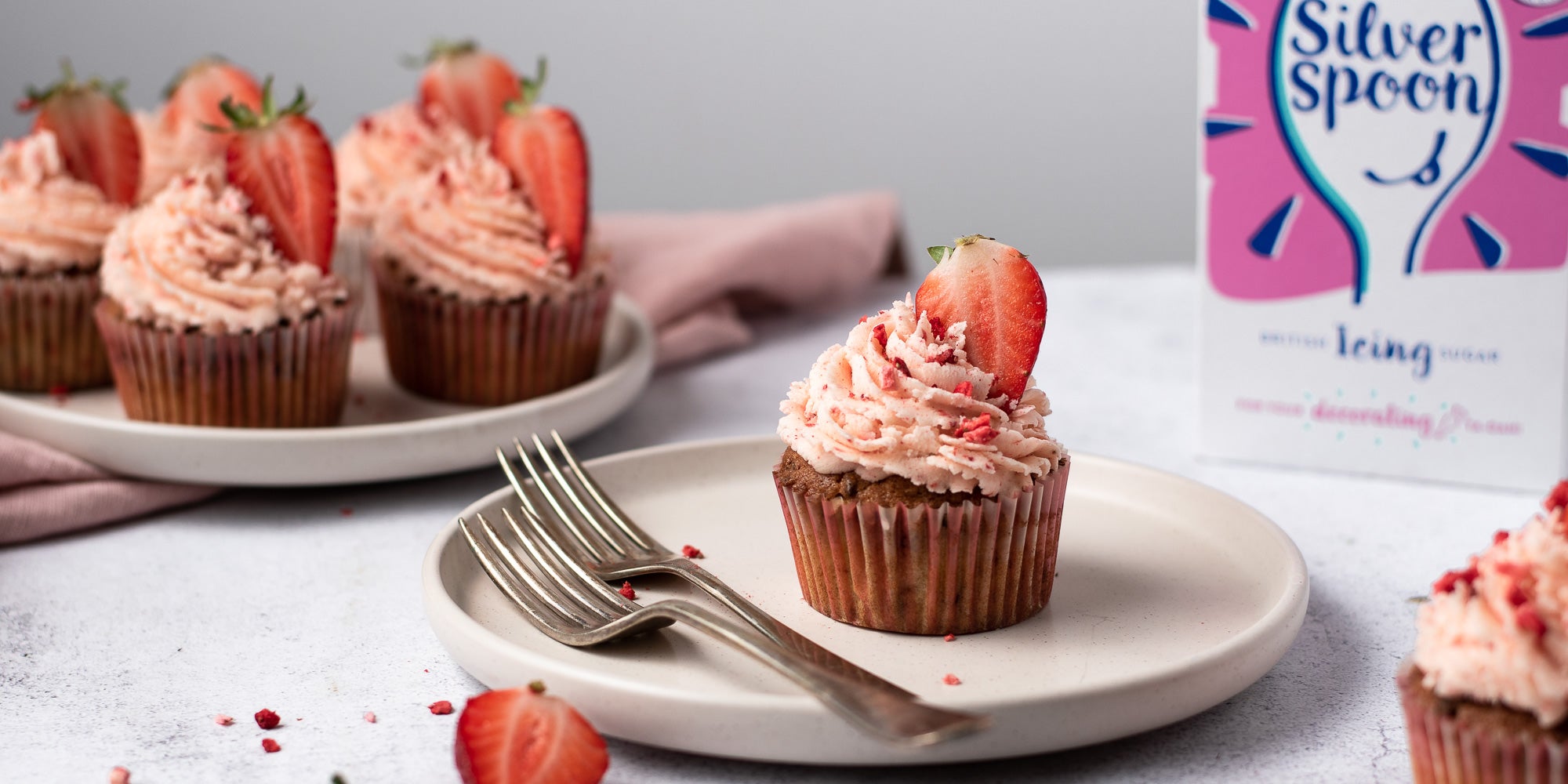 Strawberry cupcakes topped with strawberry buttercream 