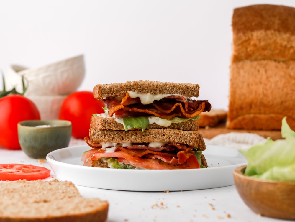 BLT sandwich on wholemeal bread on a white plate