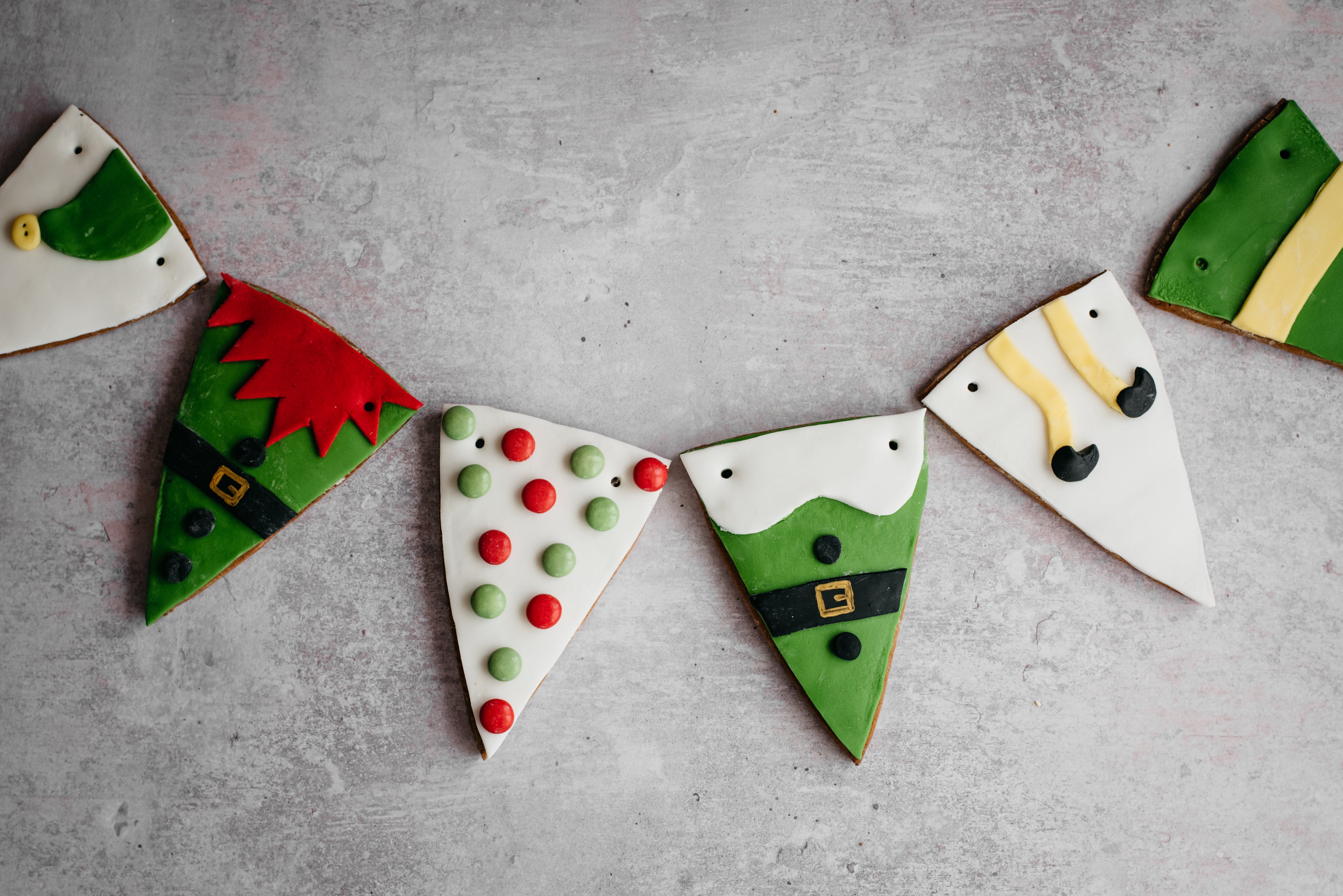 HoHoHo Elf Bunting close up, decorated with elf designs ready to be threaded with twine