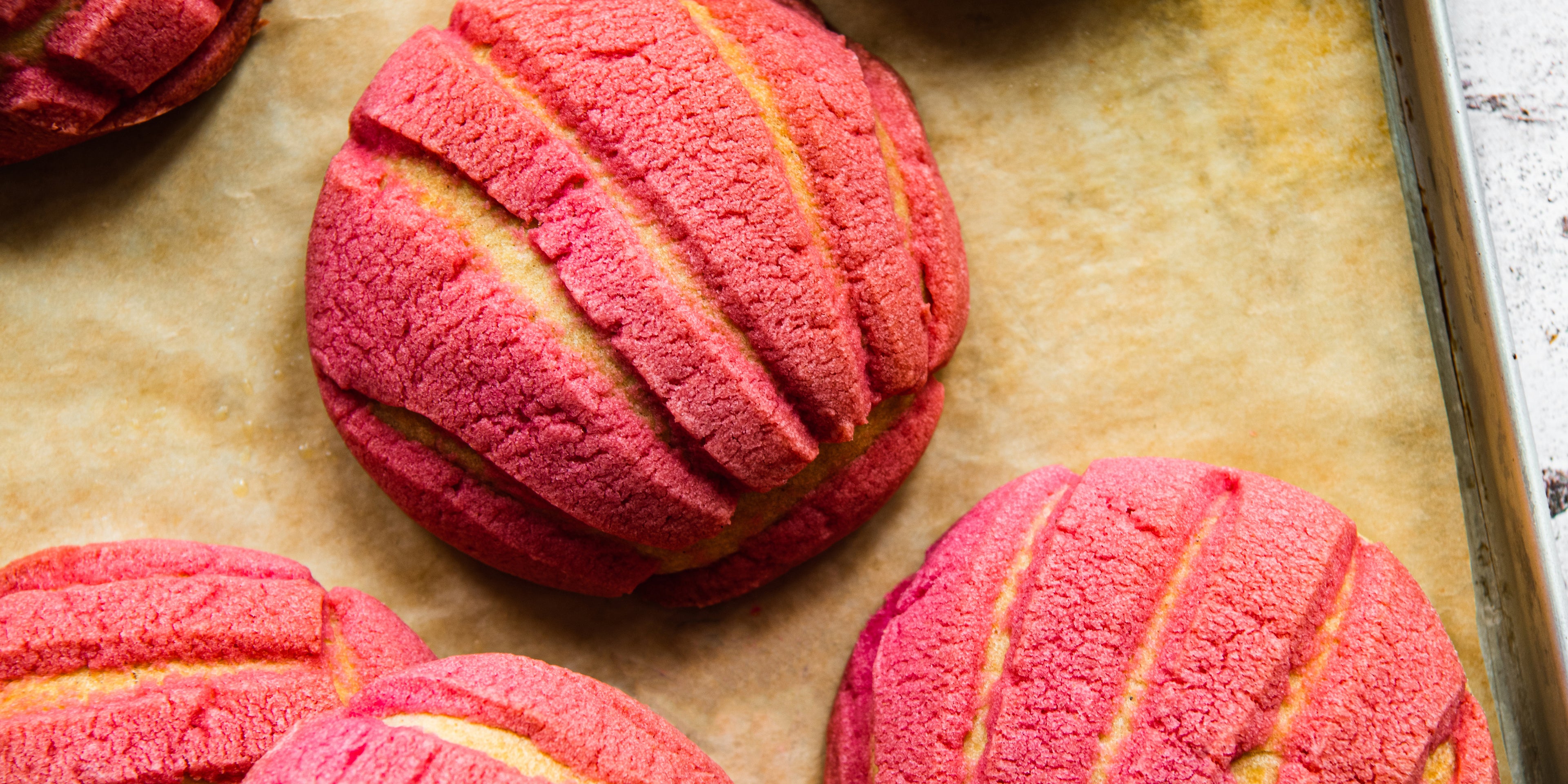 Close up of Conchas with pink decorated layer, fresh out of the oven.