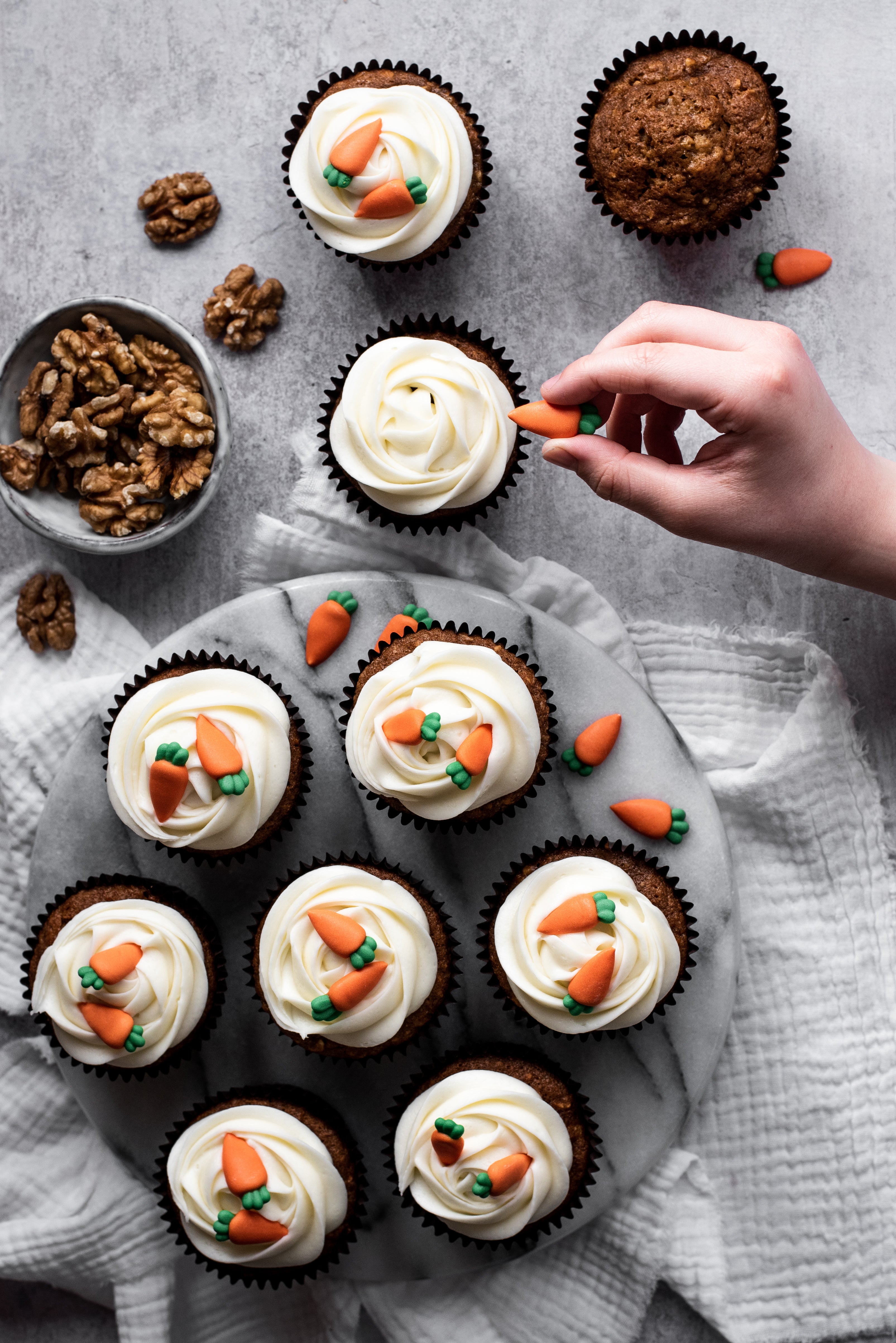 Carrot cake cupcakes with cream cheese icing and carrot decorations