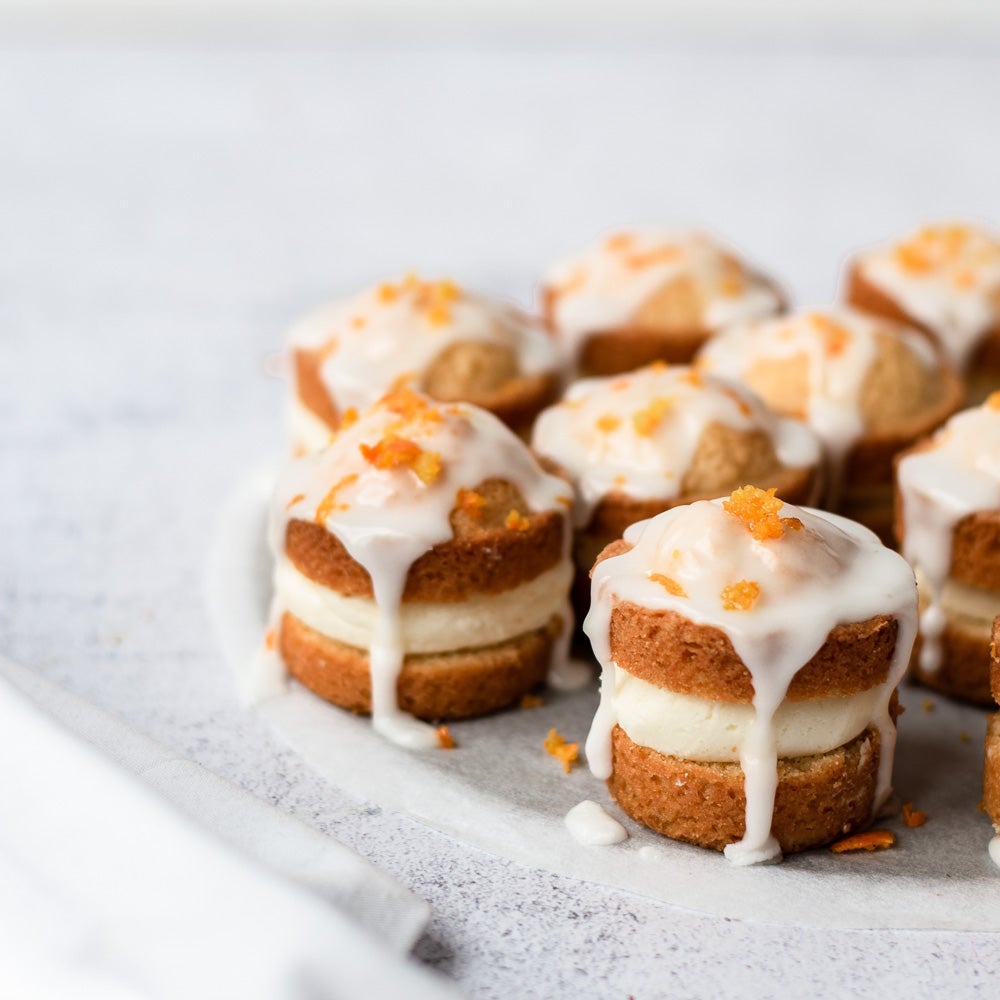 mini orange sponge cakes with glace icing on top 