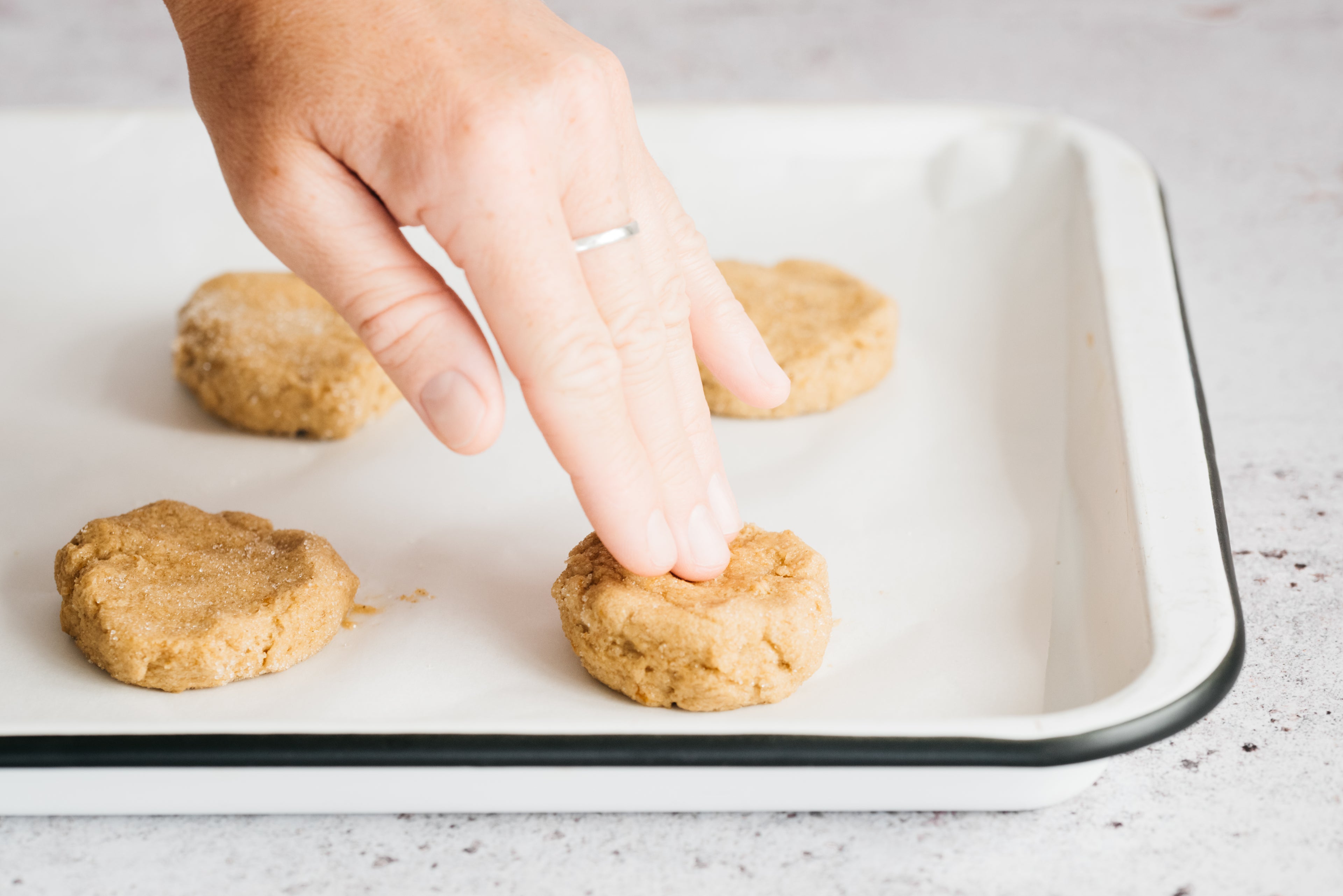 Hand pushing down cookie dough