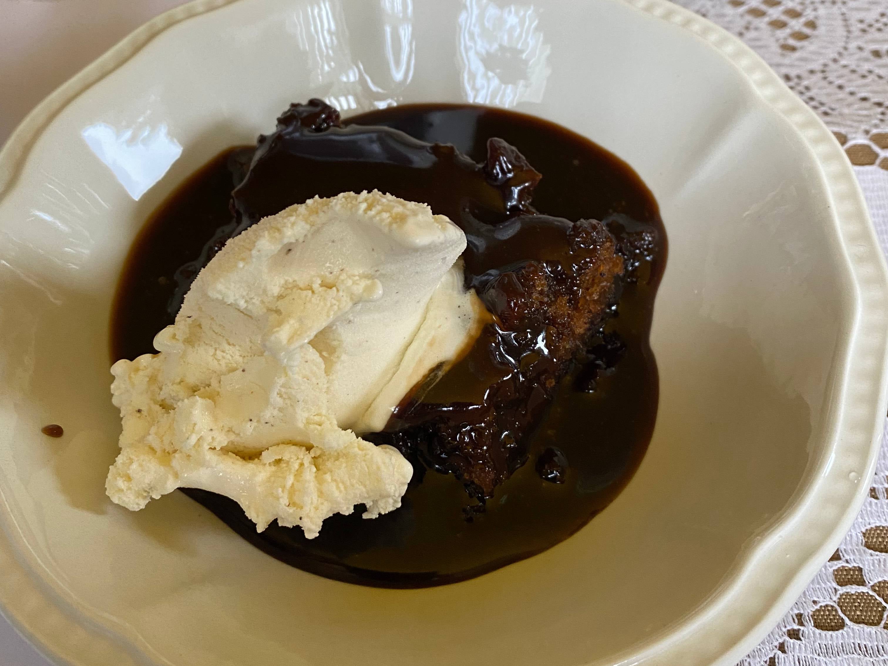 Mary Berry and Nigella Lawson sticky toffee pudding recipe with vanilla ice cream in white bowl