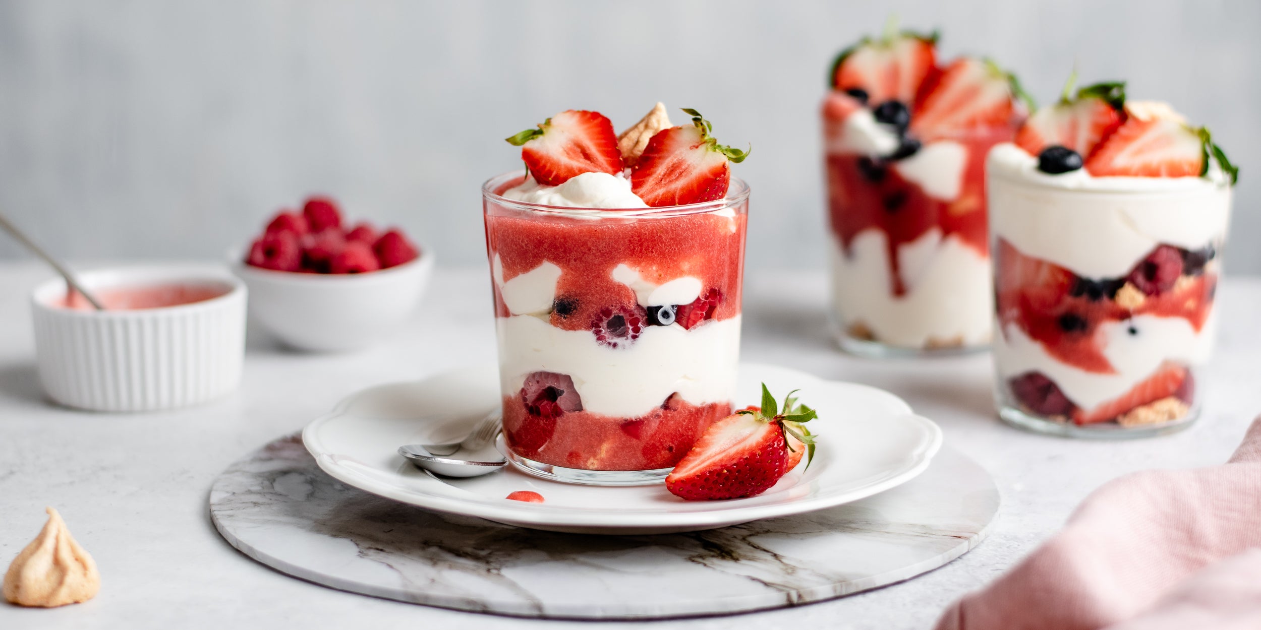 Close up of Summer Berry Eton Mess served on a plate, layered with fresh strawberries and dollops of cream using Truvia